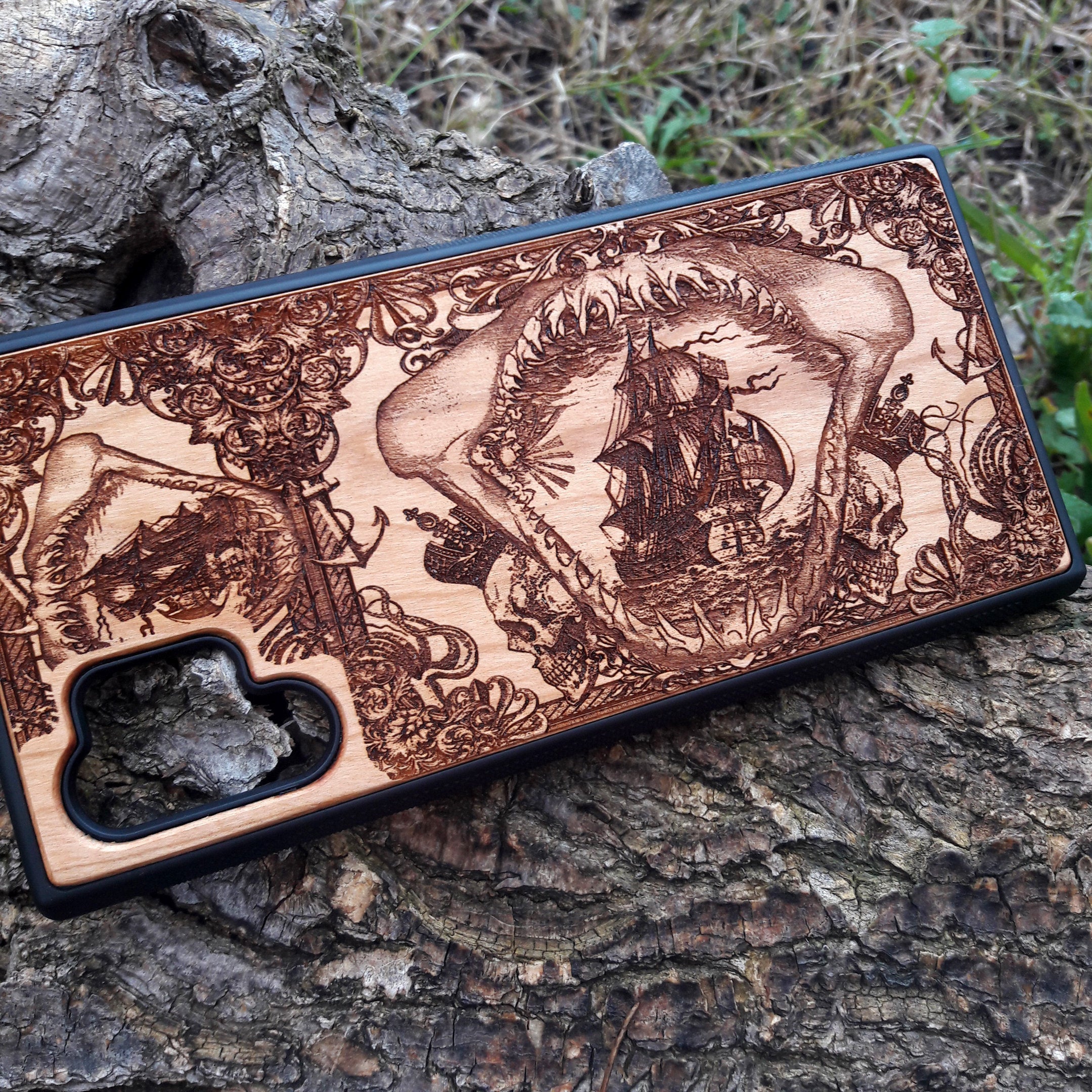 Wooden phone case with an intricate marine shark mandible design, featuring a detailed shipwreck and nautical elements. Laser-engraved on high-quality wood, this case is compatible with iPhone , iPhone 15, Samsung Galaxy S, S24, and more. Perfect for ocean lovers and those seeking a unique, eco-friendly accessory.
