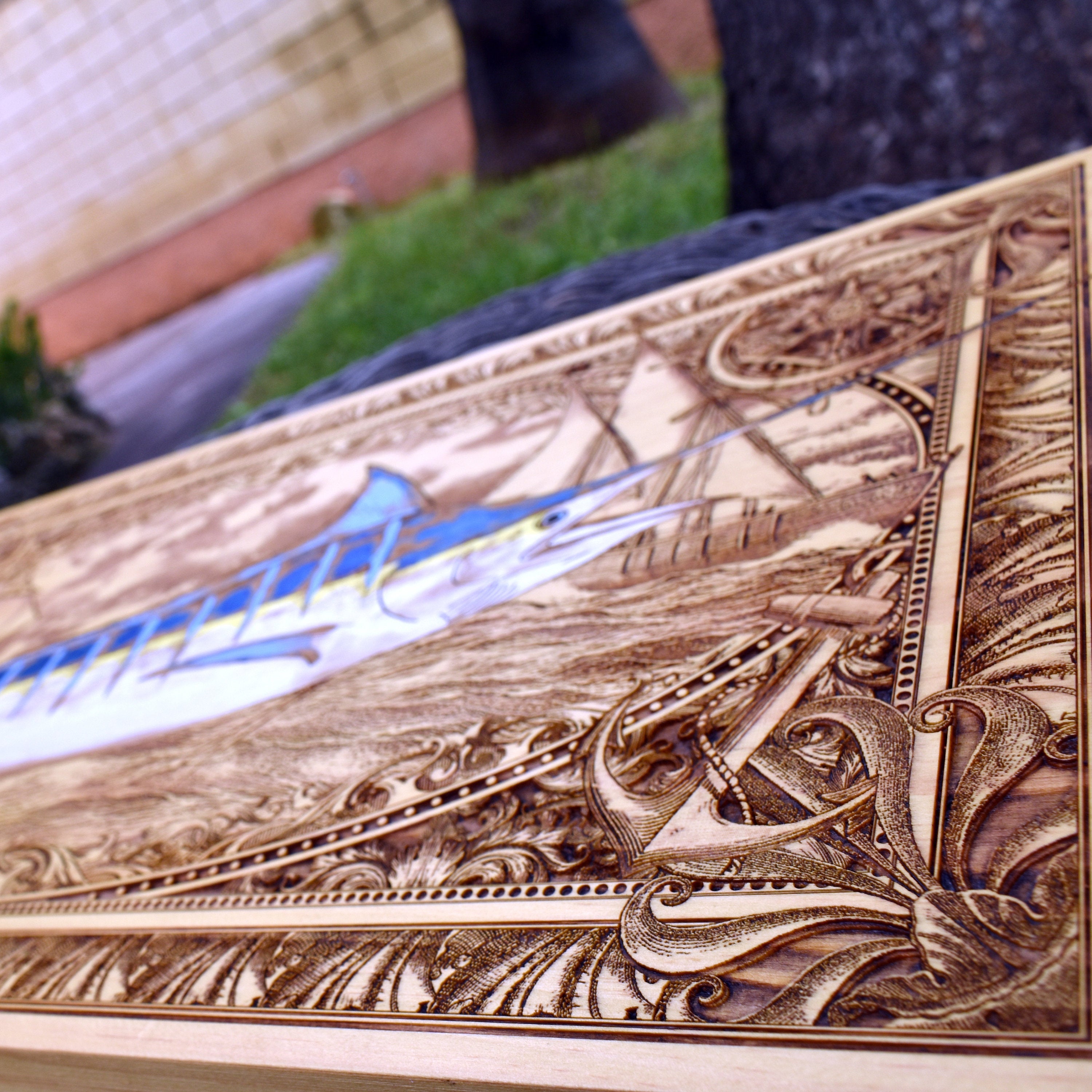 Extra-large blue marlin wood wall art, diagonal detail of the marlin and ornate nautical border