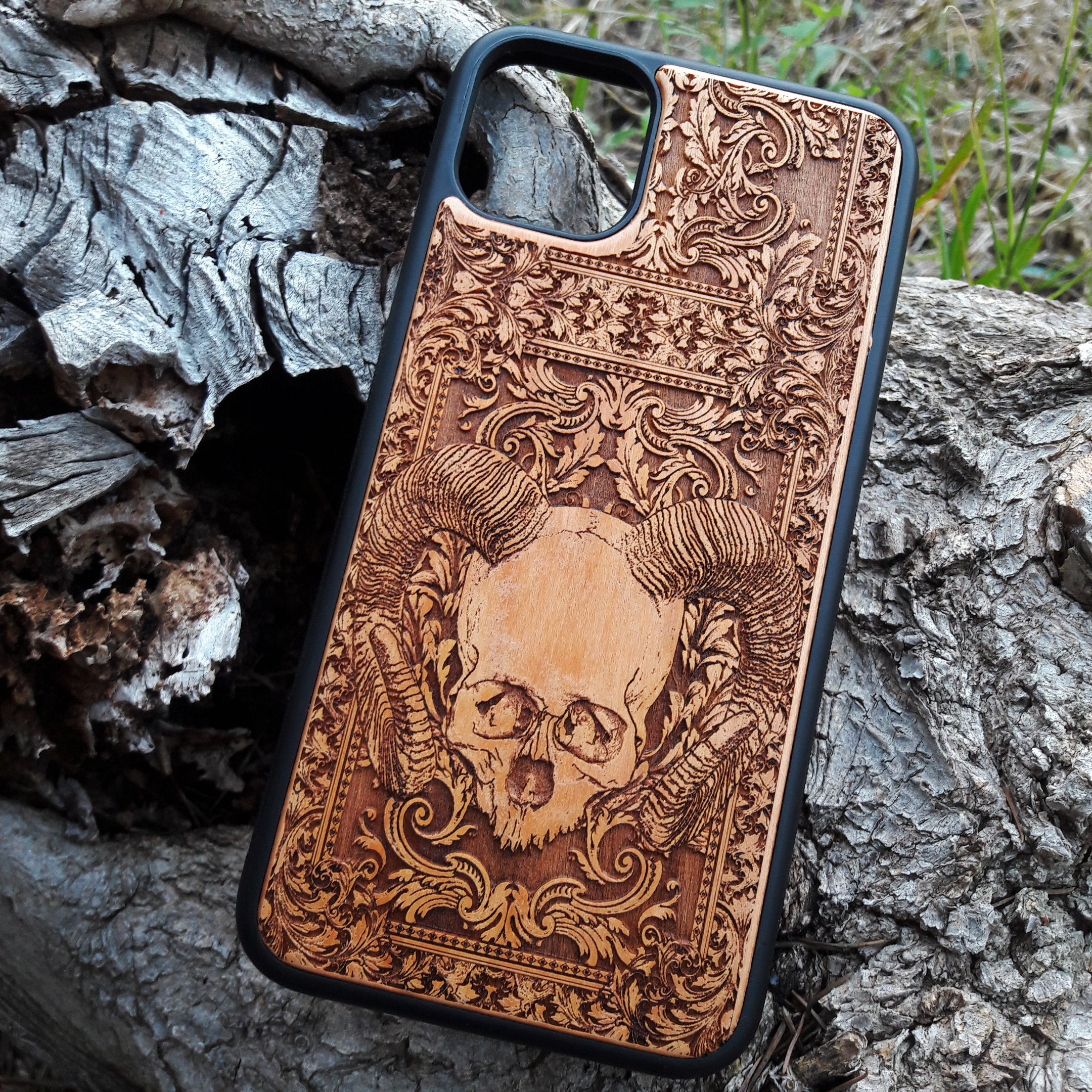 Skull and ram horns laser-engraved wooden phone case for iPhone & Samsung Galaxy – Compatible with iPhone  and Samsung Galaxy S
This optimization focuses on the dark, gothic, and alternative elements of the design, including the skull and ram horns theme, while also highlighting the compatibility with both iPhone and Samsung Galaxy models for better search engine visibility.