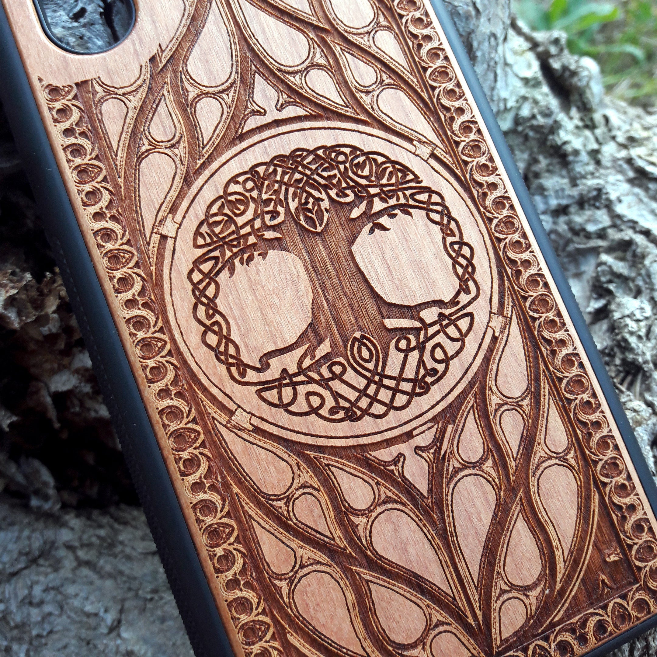 Wood phone case featuring a laser-engraved Tree of Life design surrounded by intricate Celtic-inspired patterns. Durable and stylish, this case is compatible with iPhone , 15, 14, 13, 12, 11, Pro Max, Mini, and Samsung Galaxy S, S24, S23, S22, S21, S20 Ultra, Plus, Note 20. A perfect accessory for nature lovers and fans of Celtic art.