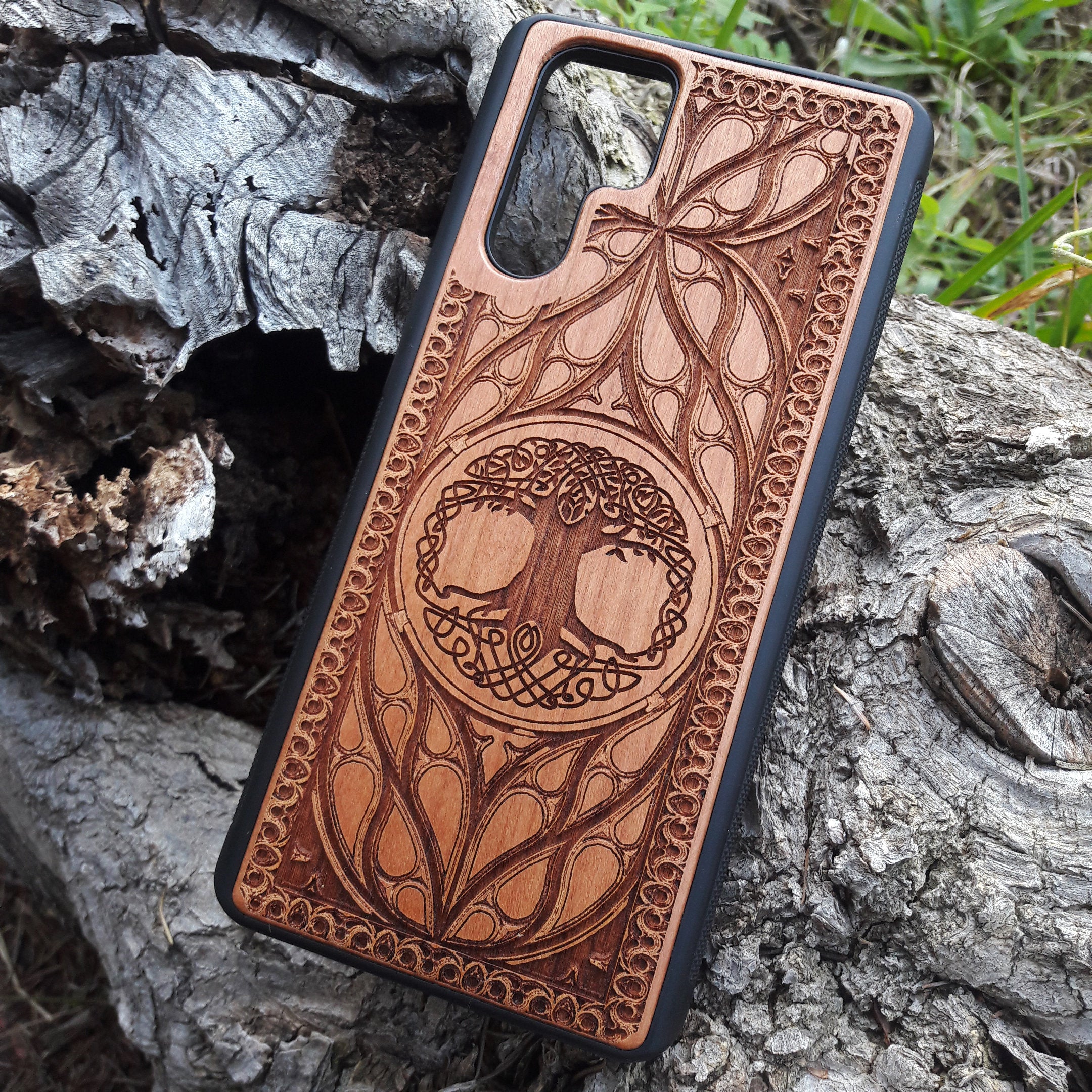 Wood phone case featuring a laser-engraved Tree of Life design surrounded by intricate Celtic-inspired patterns. Durable and stylish, this case is compatible with iPhone , 15, 14, 13, 12, 11, Pro Max, Mini, and Samsung Galaxy S, S24, S23, S22, S21, S20 Ultra, Plus, Note 20. A perfect accessory for nature lovers and fans of Celtic art.
