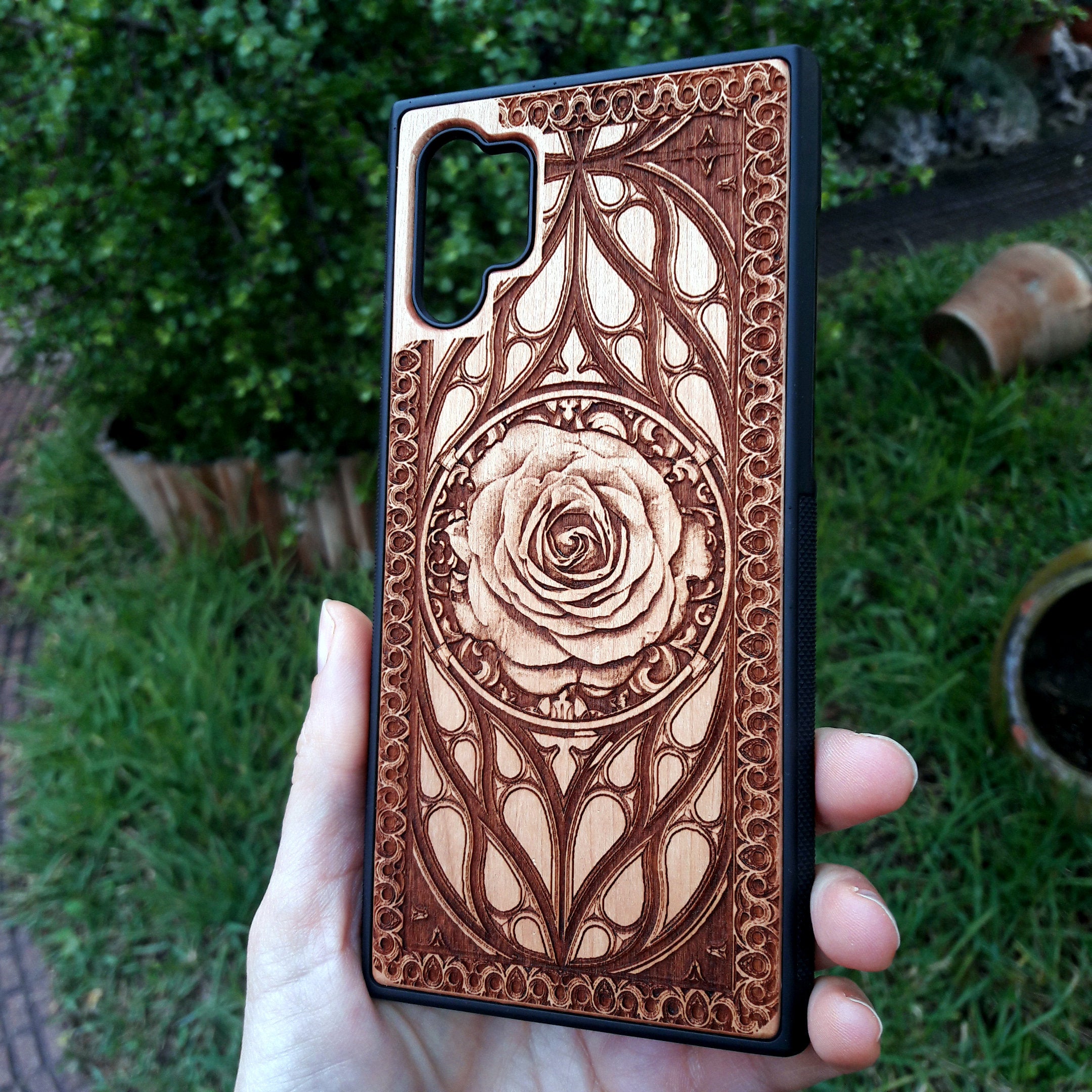 Laser-engraved wooden phone case with intricate rose design, slim, durable, and compatible with iPhone , iPhone 15, iPhone 14, iPhone 13, iPhone 12, iPhone 11, iPhone  Pro Max, iPhone  Mini, Samsung Galaxy S, Samsung Galaxy S24, Samsung Galaxy S23, Samsung Galaxy S22, Samsung Galaxy S21, Samsung Galaxy S20 Ultra, Samsung Galaxy S20 Plus, and Samsung Galaxy Note 20. Nature-inspired and unique!