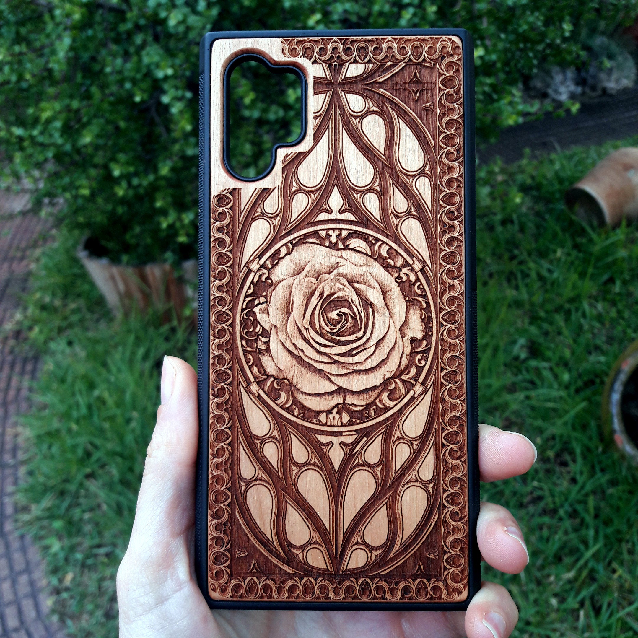 Laser-engraved wooden phone case with intricate rose design, slim, durable, and compatible with iPhone , iPhone 15, iPhone 14, iPhone 13, iPhone 12, iPhone 11, iPhone  Pro Max, iPhone  Mini, Samsung Galaxy S, Samsung Galaxy S24, Samsung Galaxy S23, Samsung Galaxy S22, Samsung Galaxy S21, Samsung Galaxy S20 Ultra, Samsung Galaxy S20 Plus, and Samsung Galaxy Note 20. Nature-inspired and unique!