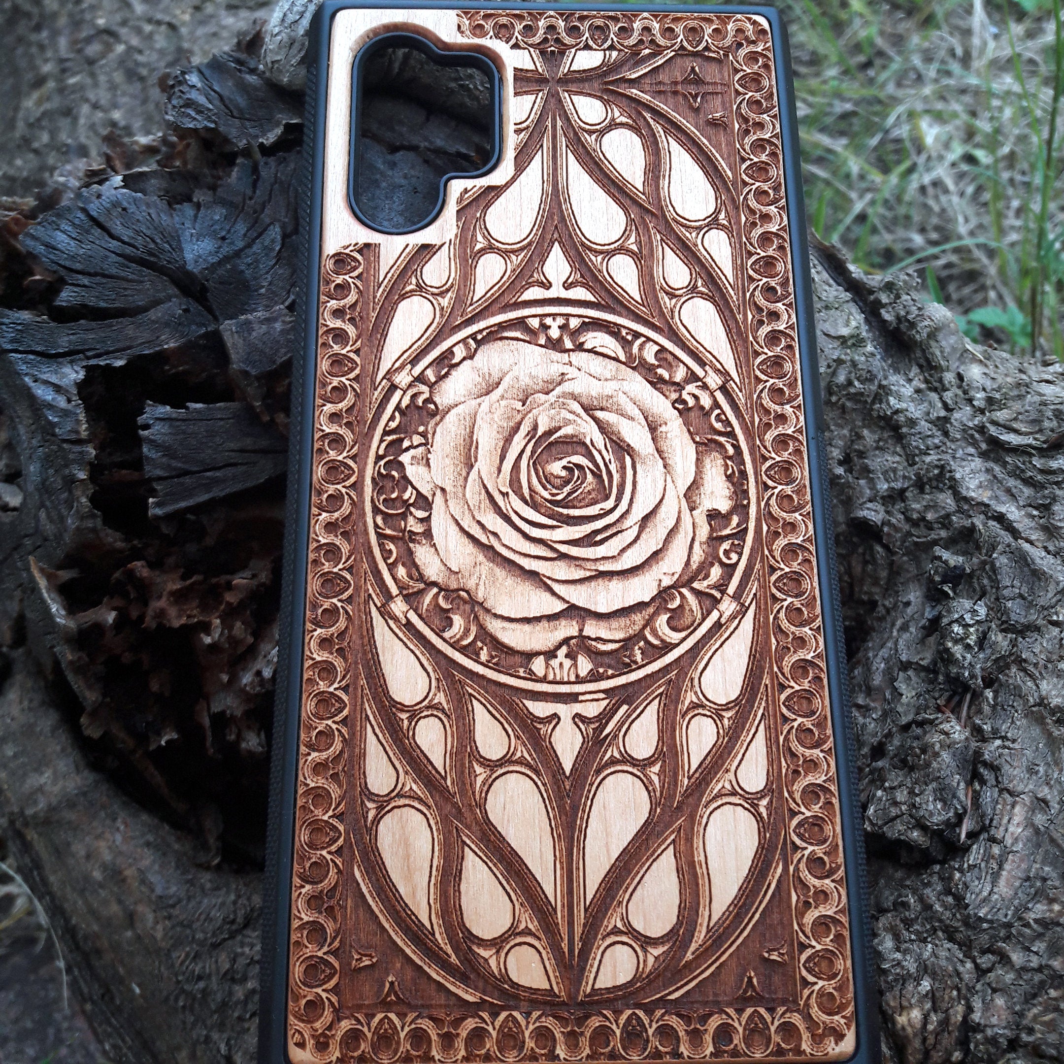 Laser-engraved wooden phone case with intricate rose design, slim, durable, and compatible with iPhone , iPhone 15, iPhone 14, iPhone 13, iPhone 12, iPhone 11, iPhone  Pro Max, iPhone  Mini, Samsung Galaxy S, Samsung Galaxy S24, Samsung Galaxy S23, Samsung Galaxy S22, Samsung Galaxy S21, Samsung Galaxy S20 Ultra, Samsung Galaxy S20 Plus, and Samsung Galaxy Note 20. Nature-inspired and unique!