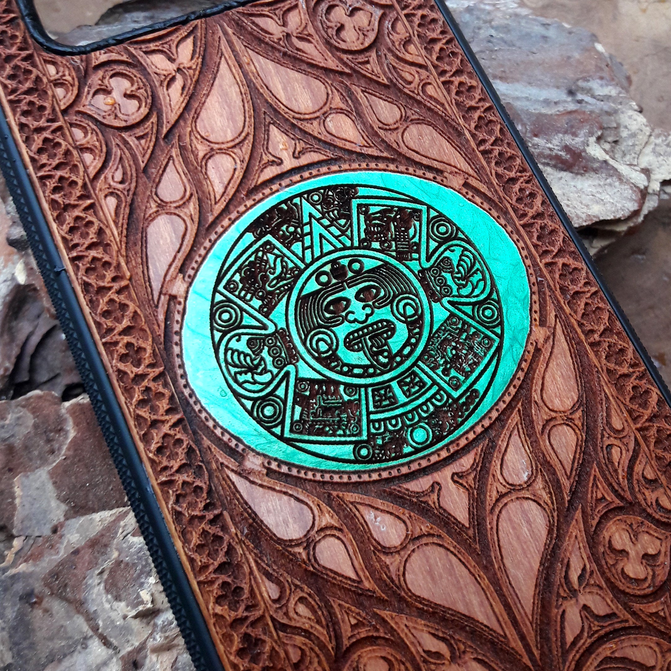Wooden phone case featuring a detailed laser-engraved design of the Eye of Sauron from Lord of the Rings. The intricate engraving showcases the dark and iconic symbol surrounded by Elvish script. Compatible with iPhone , 15, 14, 13, 12, 11 Pro Max Mini and Samsung Galaxy S, S24, S23, S22, S21, S20 Ultra, Plus, Note 20. A unique and durable accessory for Tolkien fans seeking a striking and protective phone case.