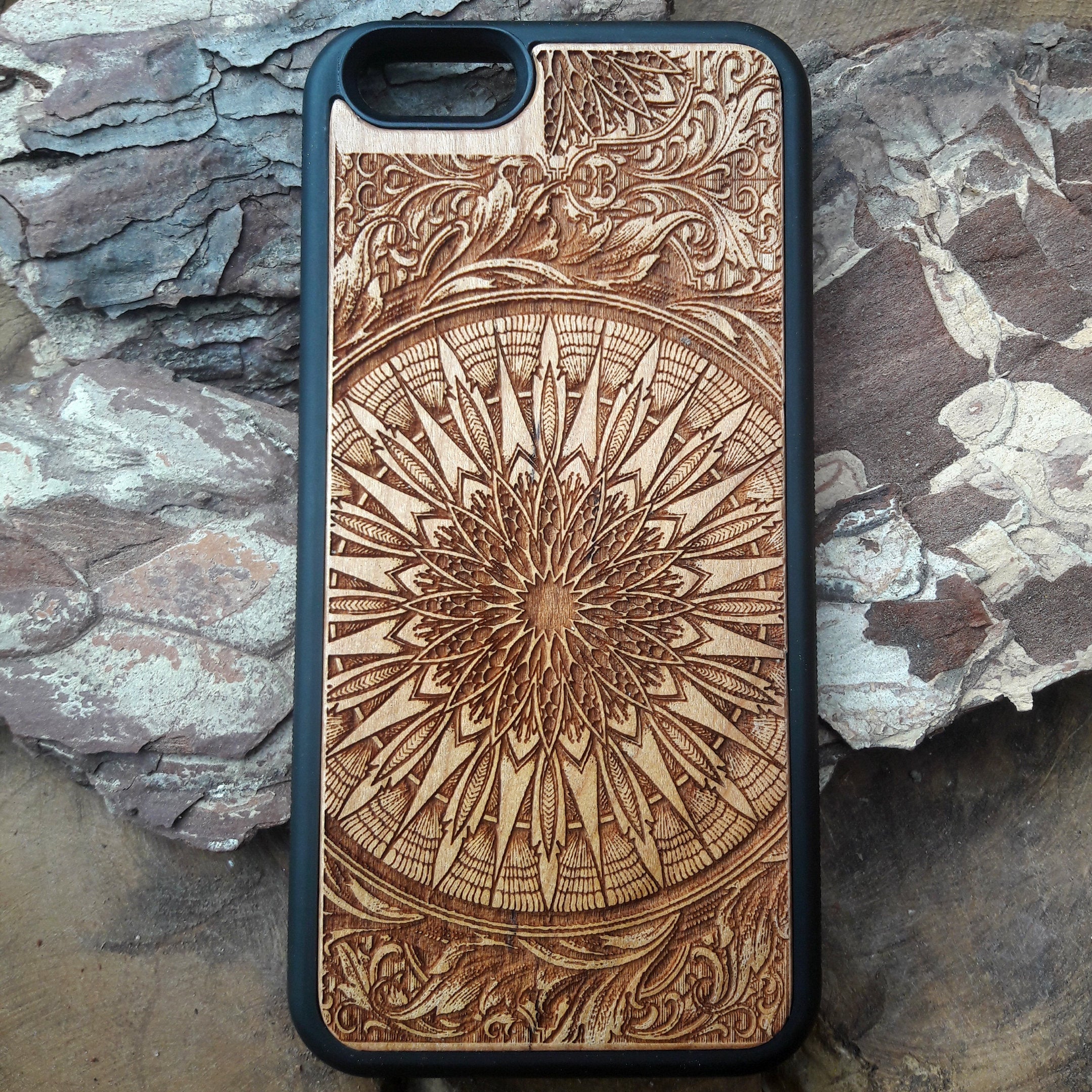 Laser-engraved wooden phone case featuring a detailed skull design, compatible with iPhone 16, iPhone 15, Galaxy S25, and more.