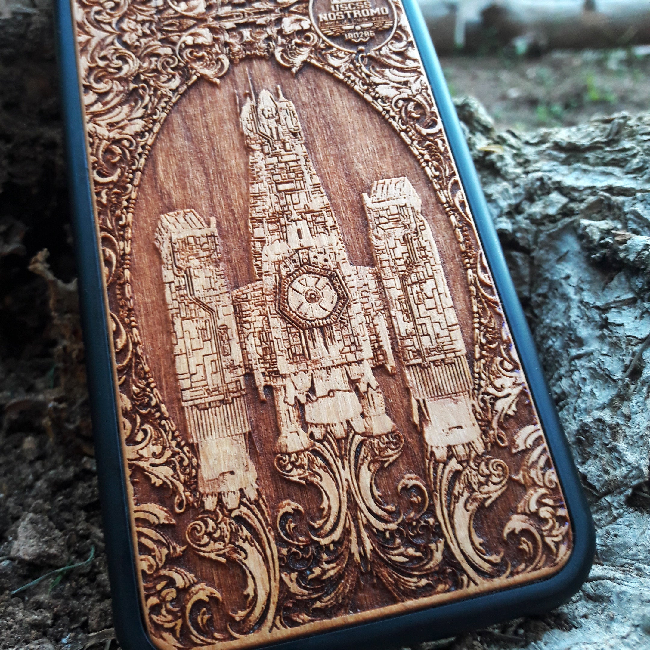 Wooden phone case with detailed Nostromo ship design from the Alien movie, engraved for iPhone , Samsung Galaxy S, and other models. Perfect for sci-fi and Alien franchise fans, offering protection and style.