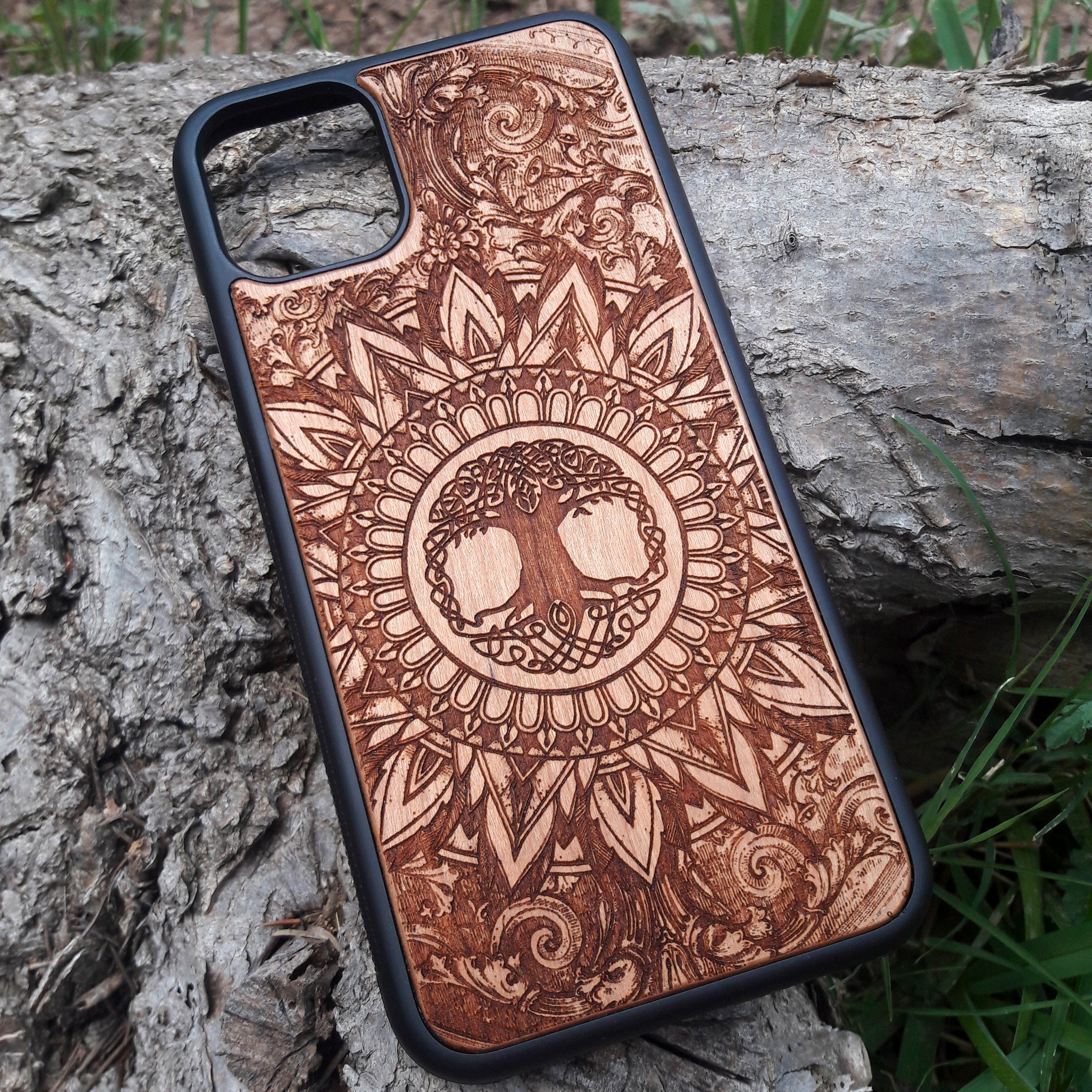 Laser-engraved wooden phone case featuring a detailed skull design, compatible with iPhone 16, iPhone 15, Galaxy S25, and more.