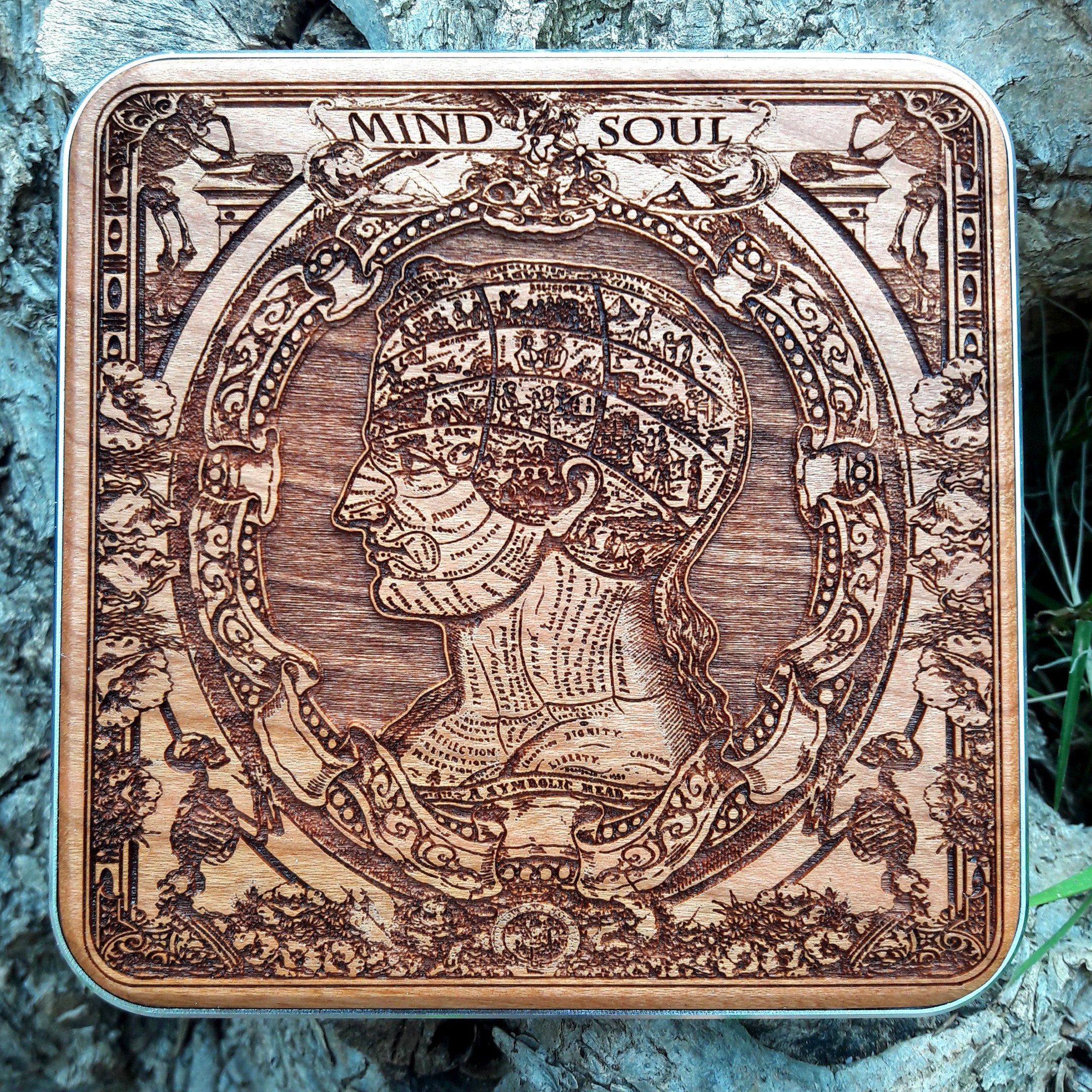 Handmade wooden wireless charger with symbolic anatomy head engraving.