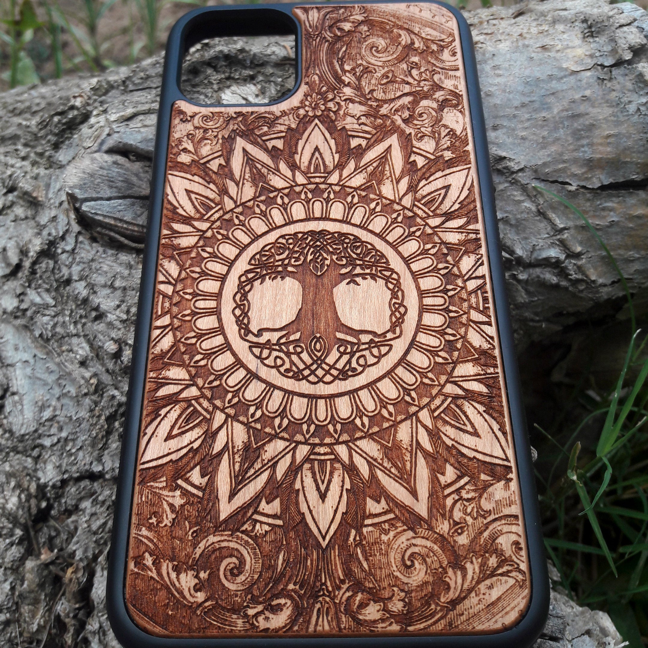 Laser-engraved wooden phone case featuring a detailed skull design, compatible with iPhone 16, iPhone 15, Galaxy S25, and more.