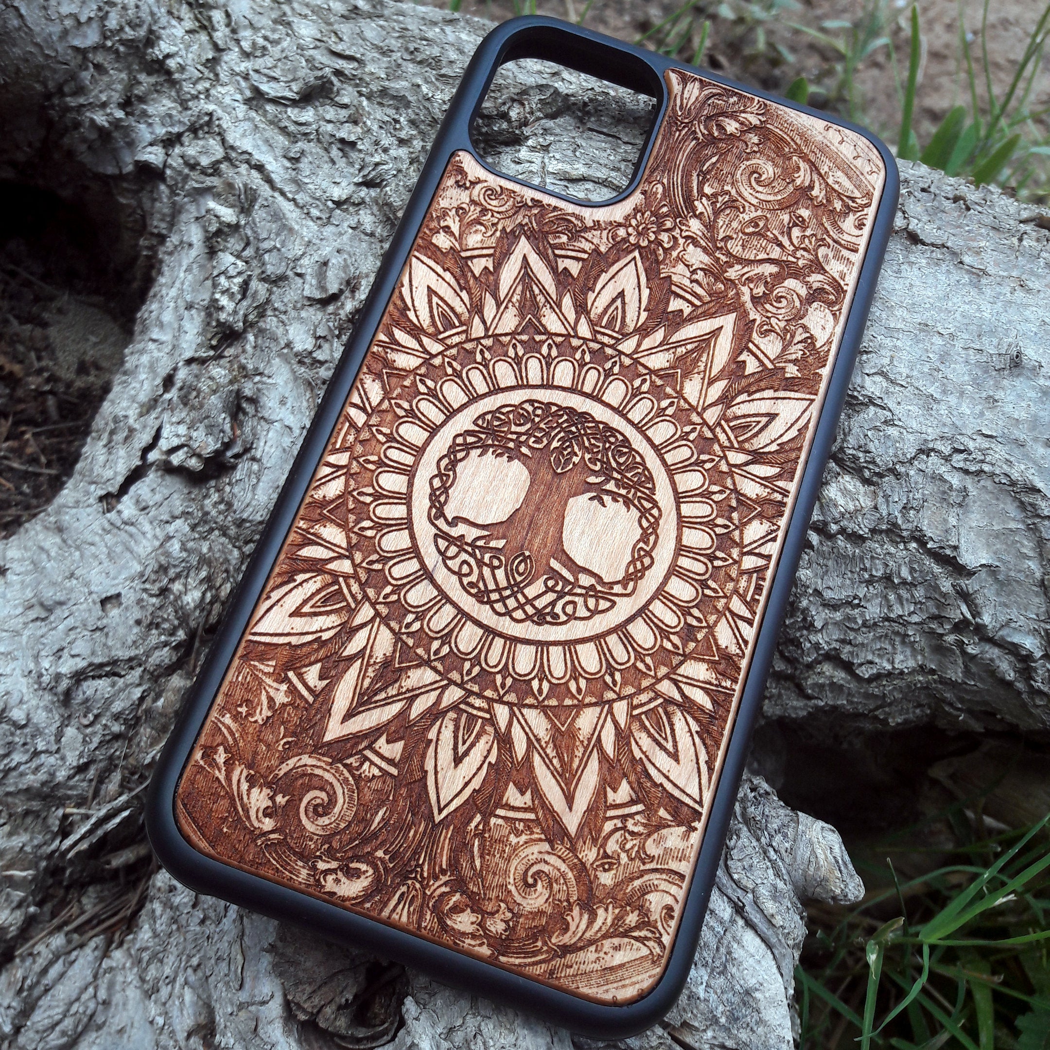 Laser-engraved wooden phone case featuring a detailed skull design, compatible with iPhone 16, iPhone 15, Galaxy S25, and more.