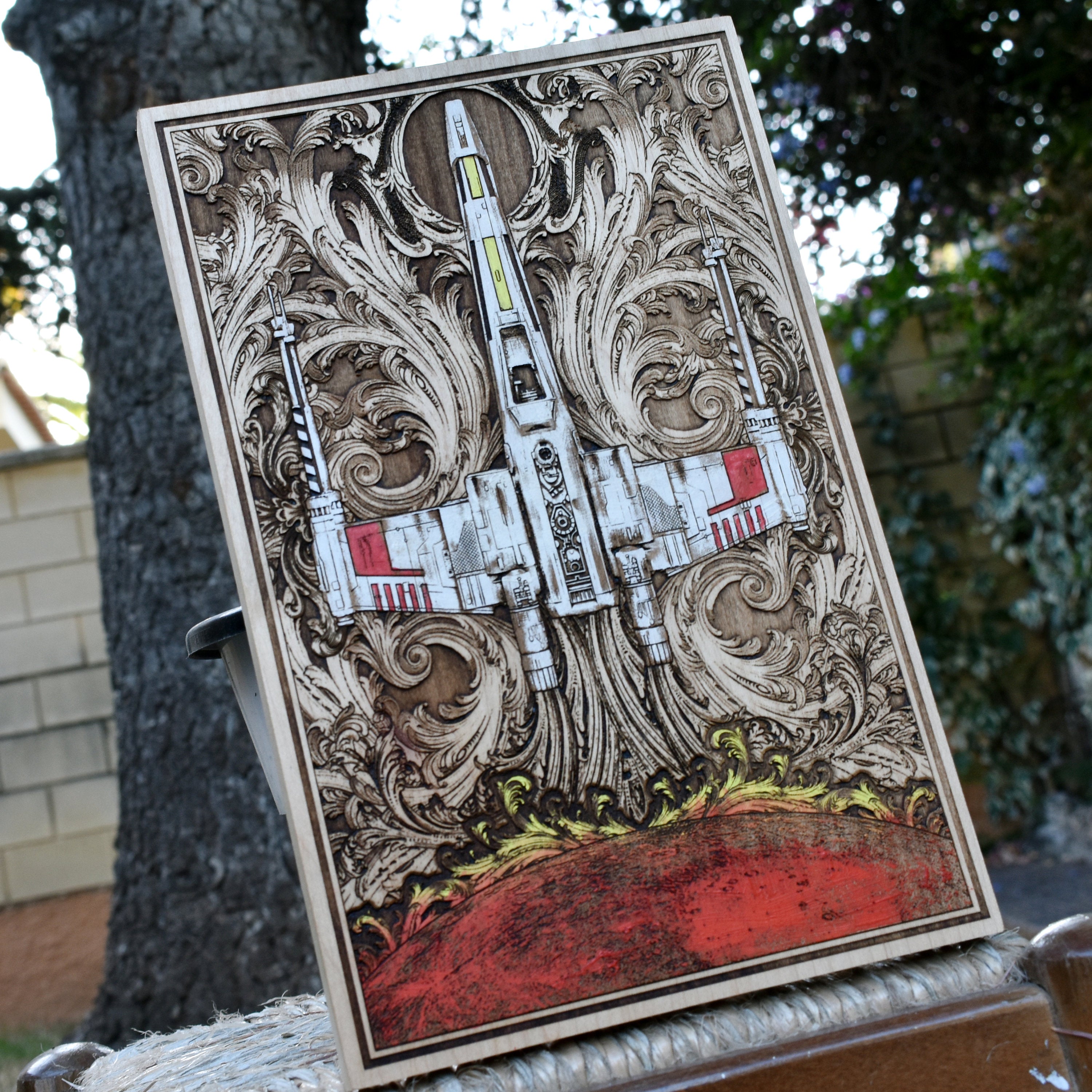 Custom wood wall art featuring a detailed Star Wars X-Wing fighter.
