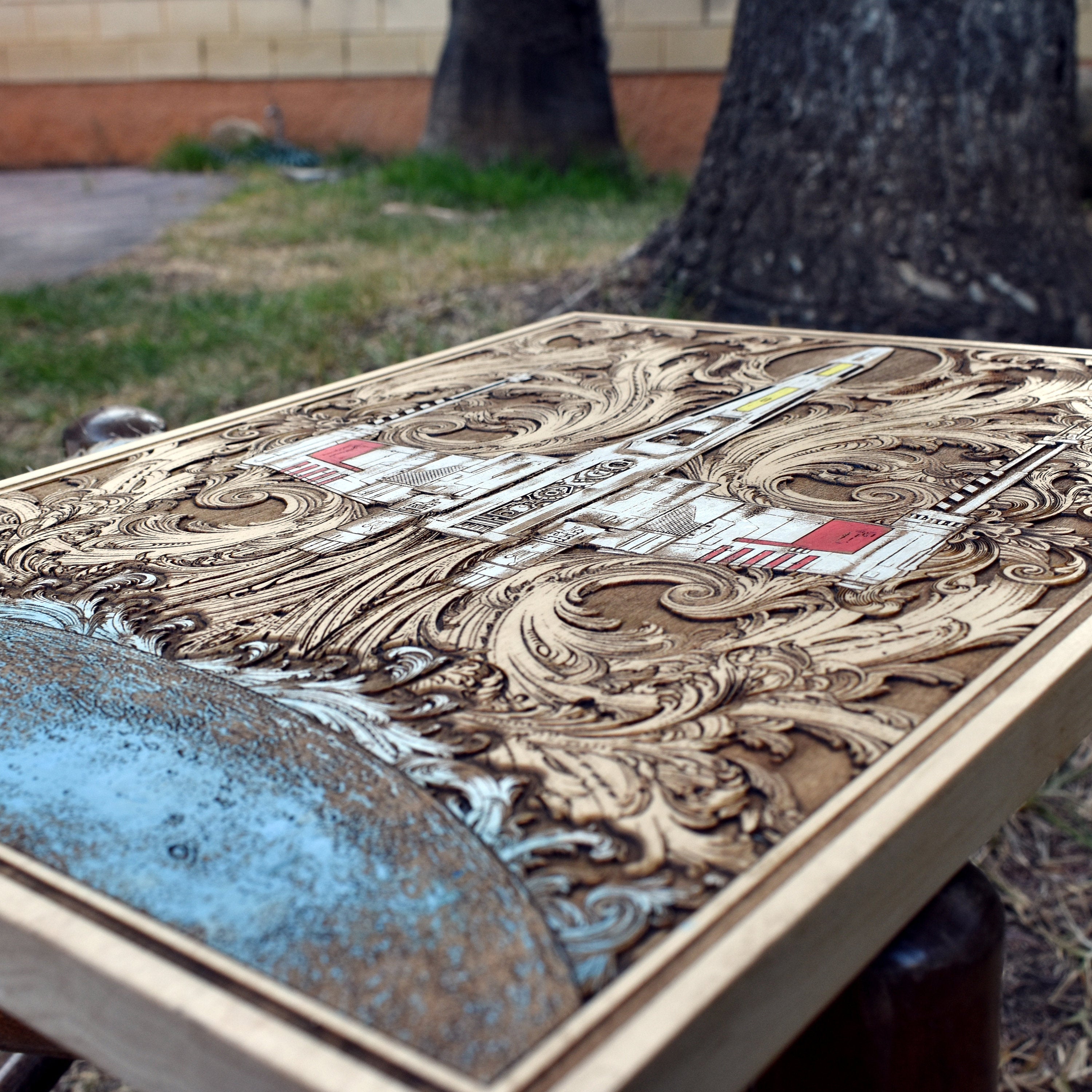 Close-up of detailed X-Wing starfighter engraving on wood