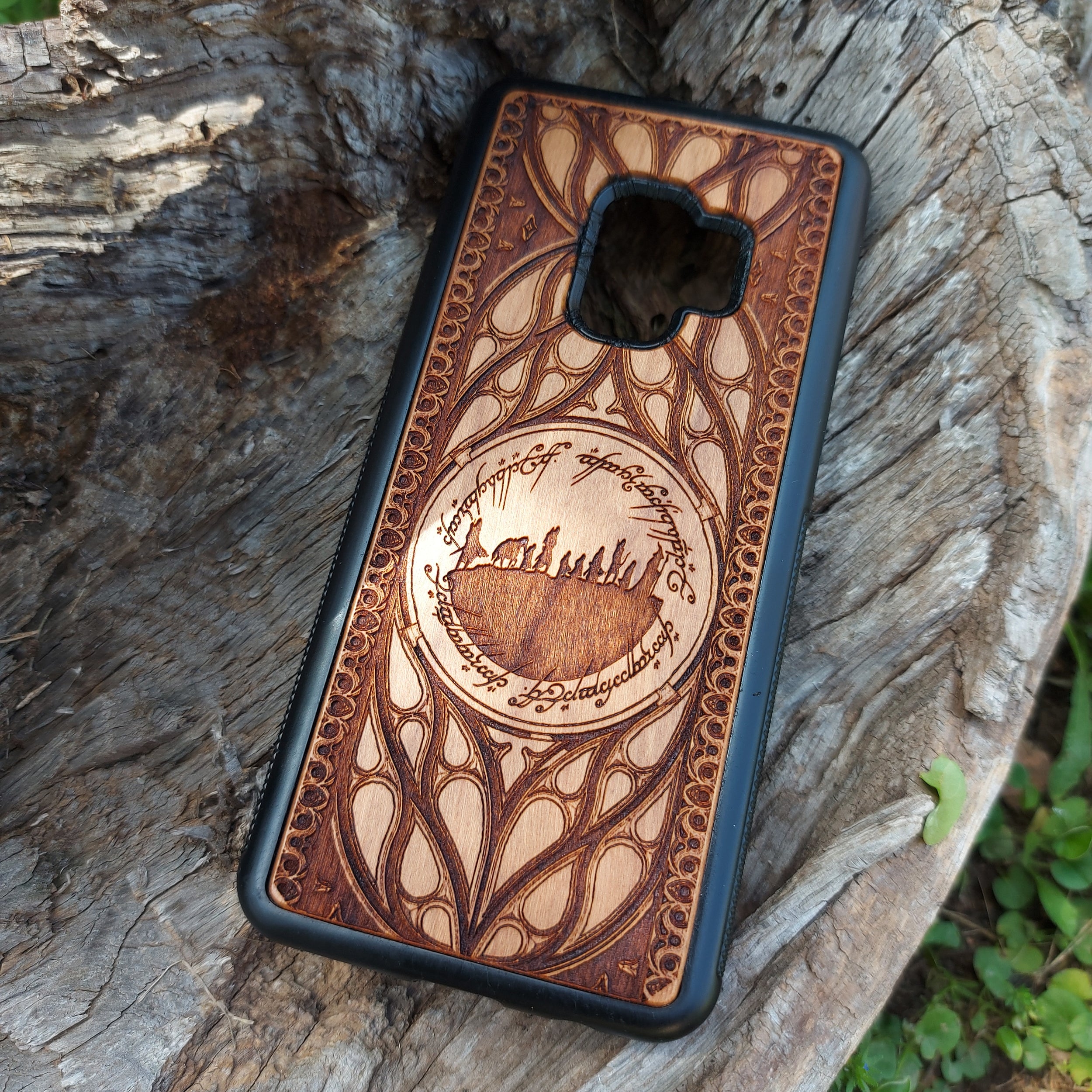 Lord of the Rings wood phone case featuring the Fellowship of the Ring silhouette surrounded by Elvish script and intricate, elegant patterns. Laser-engraved for precision and durability, this case is compatible with iPhone , 15, 14, 13, 12, 11, Pro Max, Mini, and Samsung Galaxy S, S24, S23, S22, S21, S20 Ultra, Plus, Note 20. A unique and protective accessory for Tolkien fans.