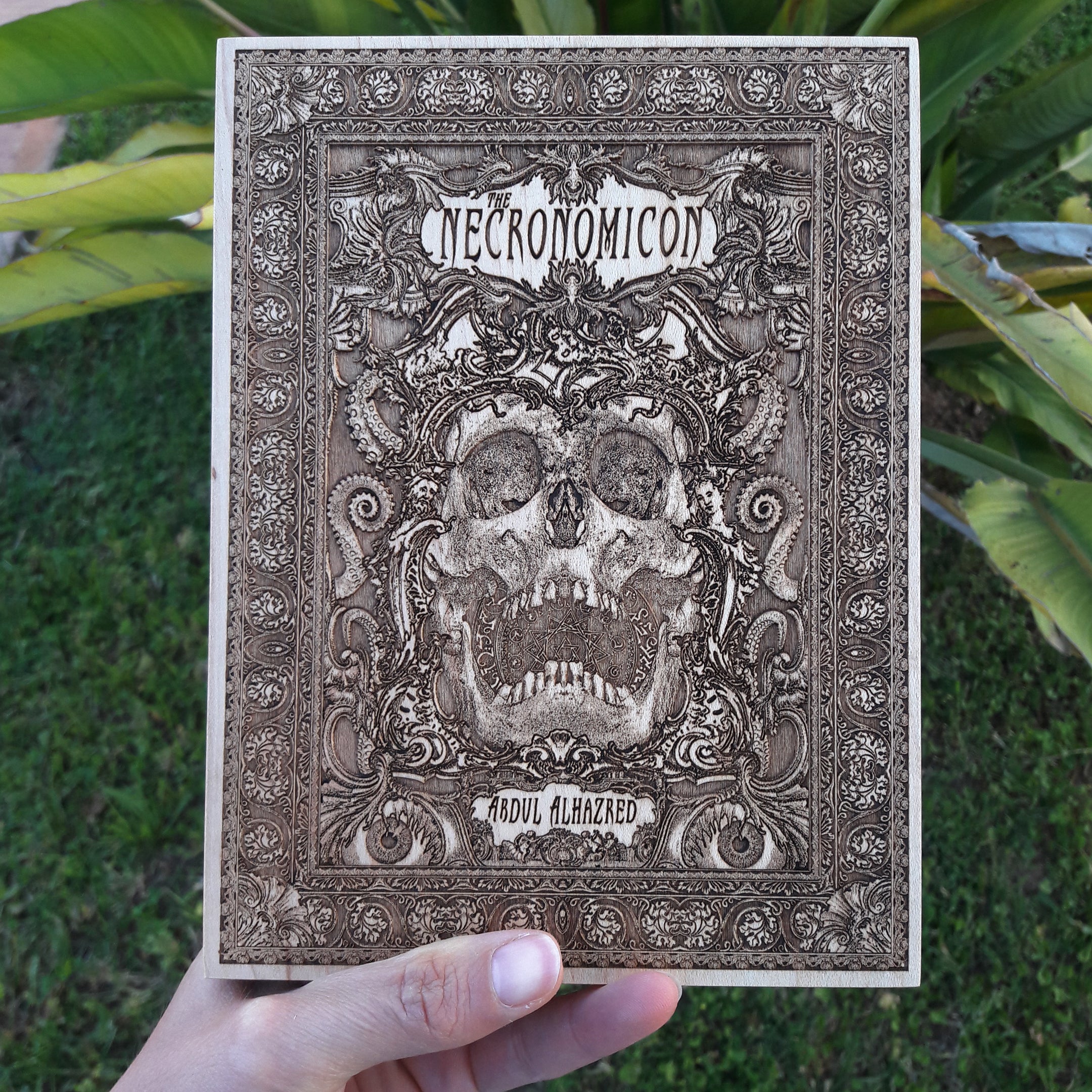 Dark Lovecraftian wood engraving with Necronomicon-inspired design.