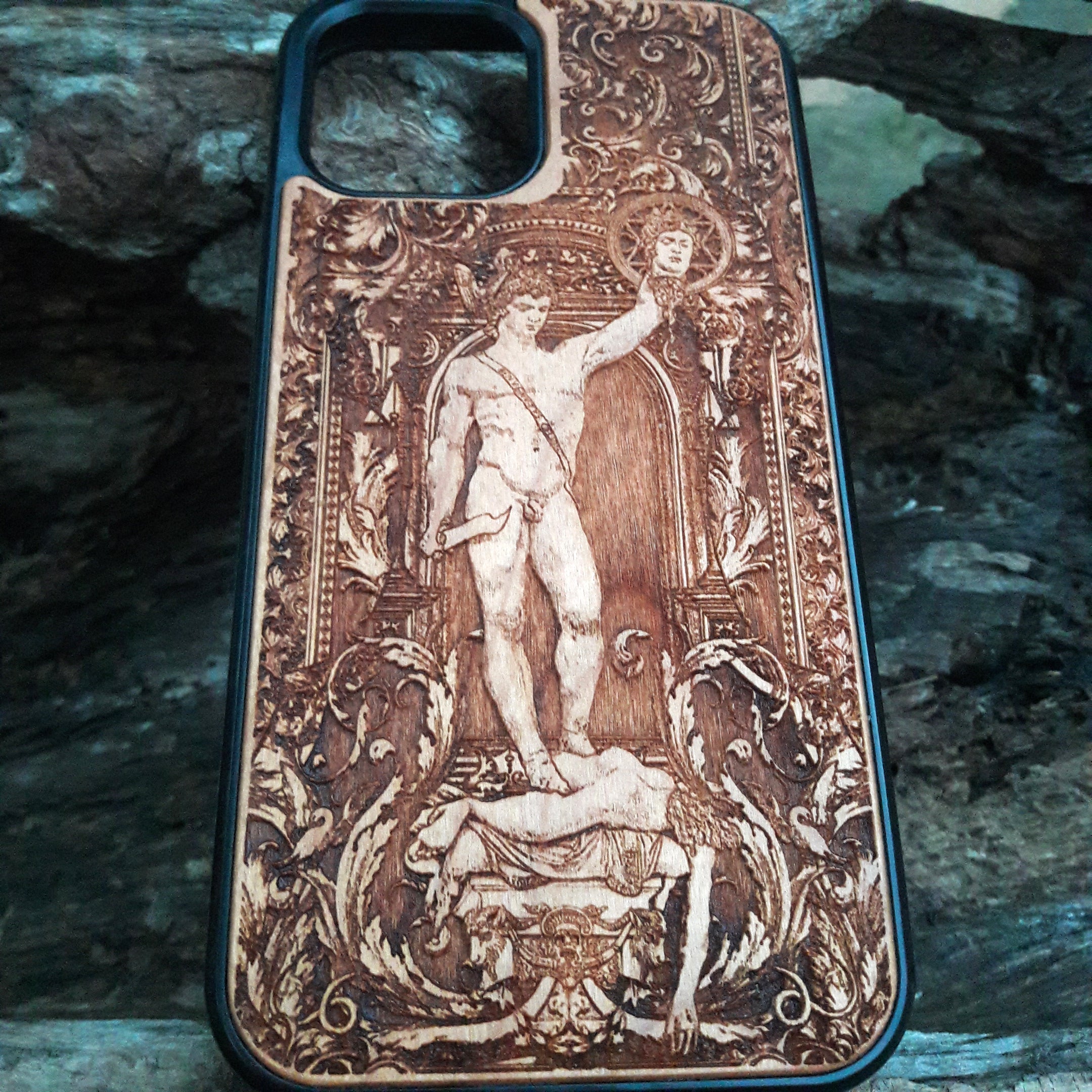 Wooden phone case featuring Perseus with the Head of Medusa, intricately carved for iPhone , iPhone 15, Samsung Galaxy S, S24, and more. Ideal for fans of mythology and gothic art, offering durable protection with a unique design.