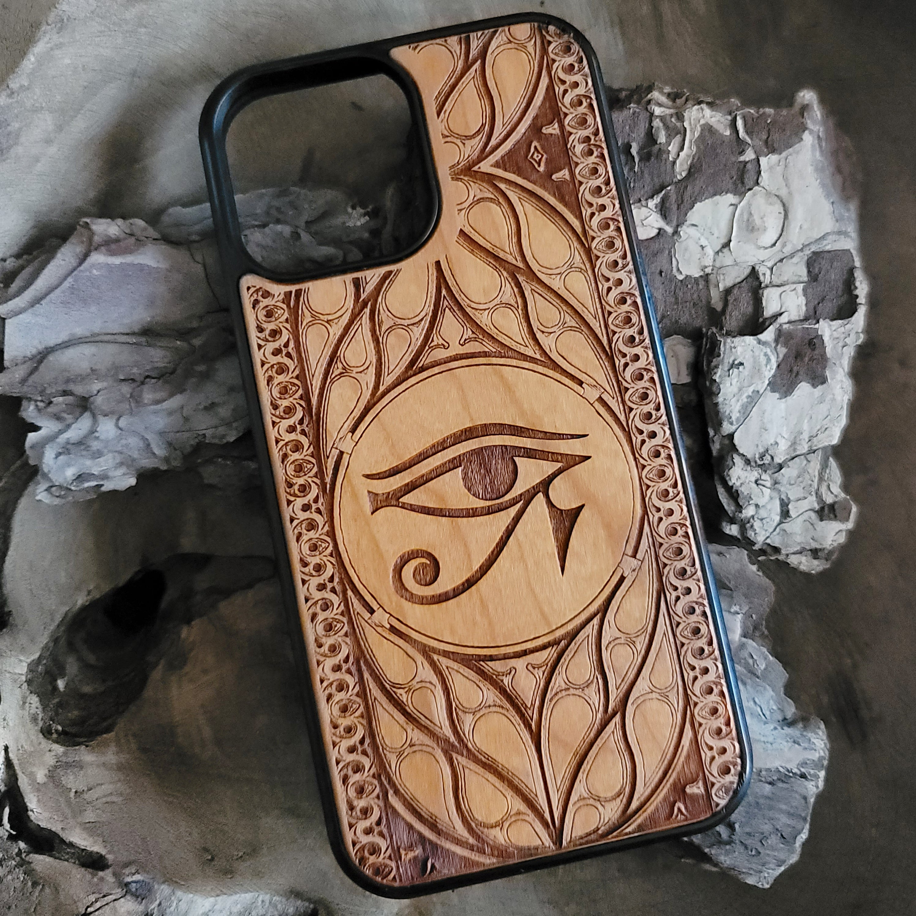 Wooden phone case featuring the Eye of Ra design, laser-engraved for iPhone & Samsung Galaxy. Compatible with iPhone 15, 14, 13, 12, 11 Pro Max Mini, Samsung Galaxy S24, S23, S22, S21, S20 Ultra Plus, and Note 20. Unique, durable, and slim.