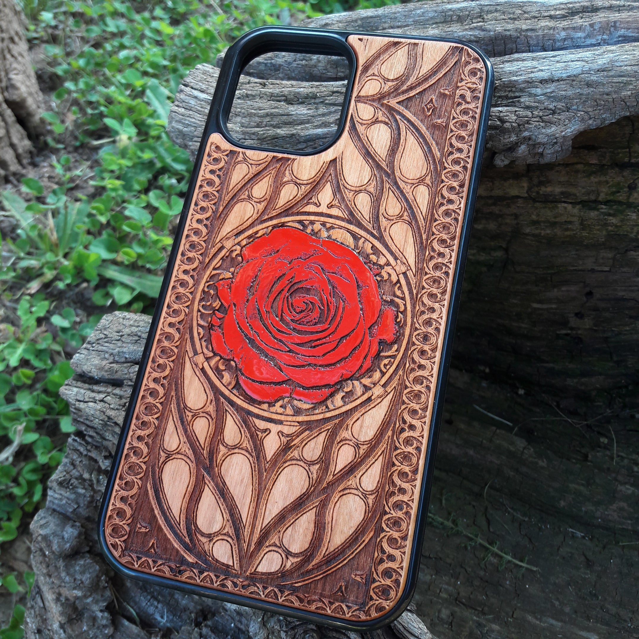 Laser-engraved red rose design on a wooden phone case, featuring intricate floral artwork, compatible with iPhone 16, iPhone 15, Galaxy S25, and more.
