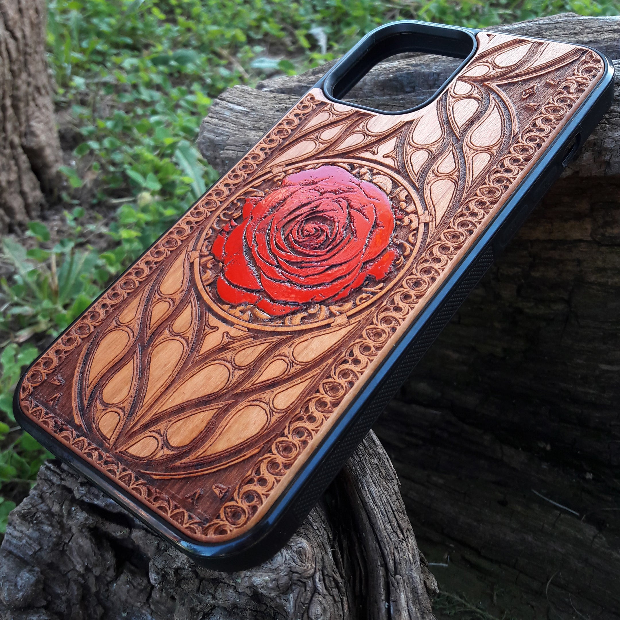Laser-engraved red rose design on a wooden phone case, featuring intricate floral artwork, compatible with iPhone 16, iPhone 15, Galaxy S25, and more.