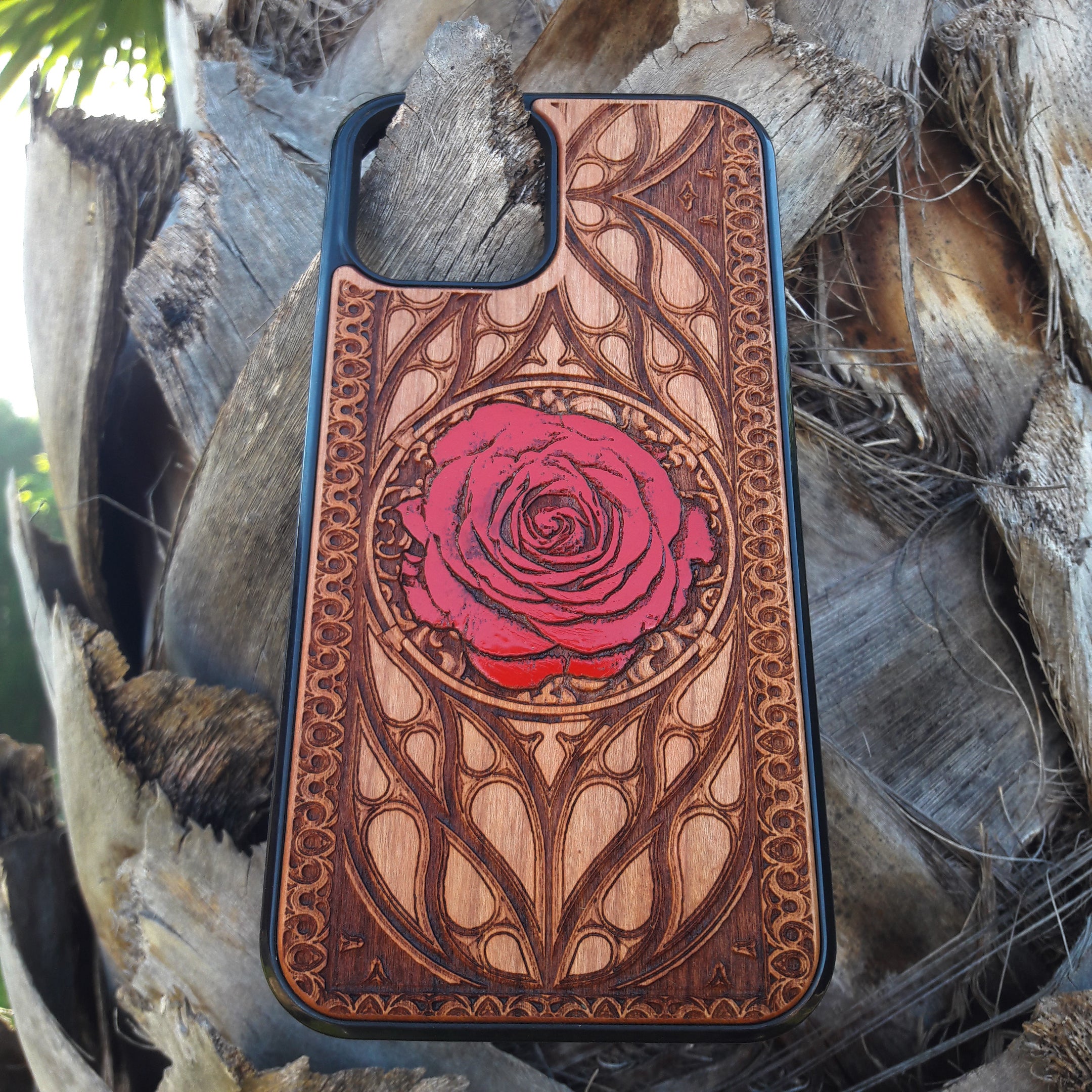 Laser-engraved red rose design on a wooden phone case, featuring intricate floral artwork, compatible with iPhone 16, iPhone 15, Galaxy S25, and more.