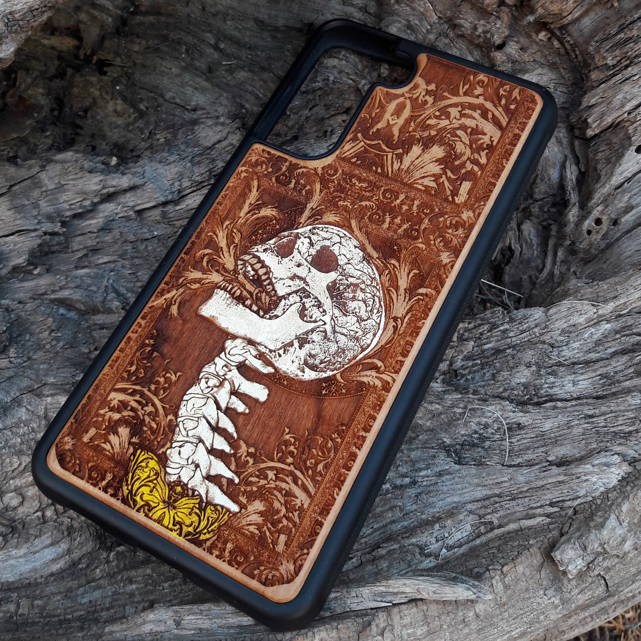 Gothic skull artwork engraved on a wooden phone case, compatible with iPhone and Samsung Galaxy