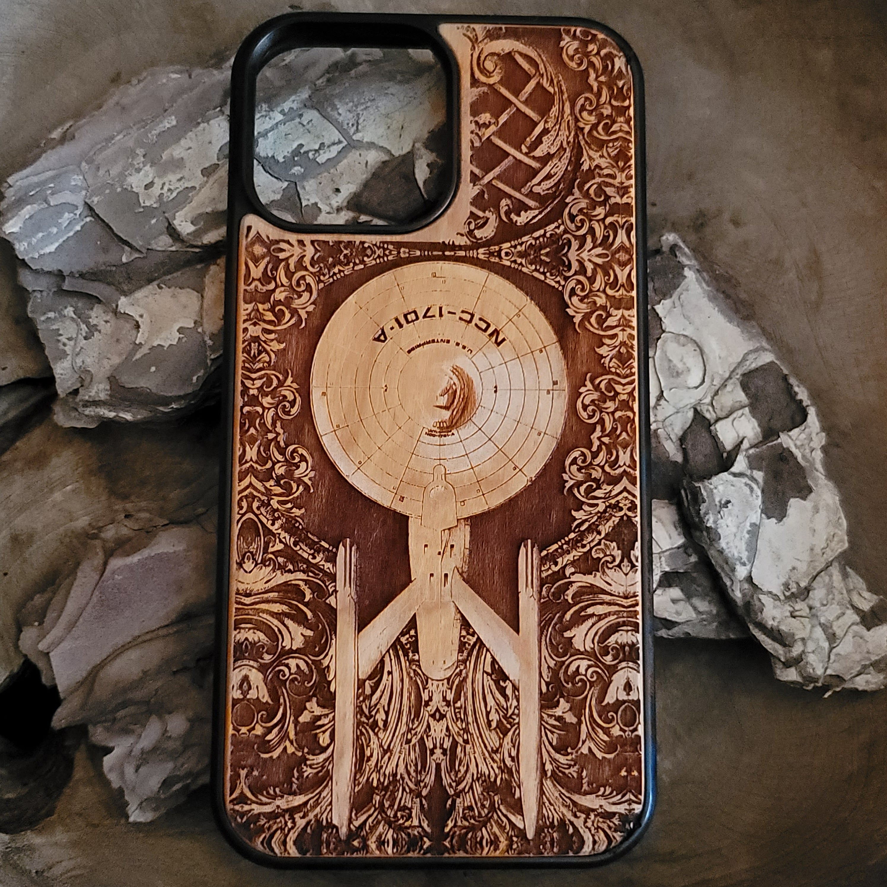 Wooden phone case featuring a detailed carving of the Starship Enterprise NCC-1701A, designed for iPhone , iPhone 15, Galaxy S, and more. Ideal for Star Trek fans looking for a unique, sci-fi inspired accessory.