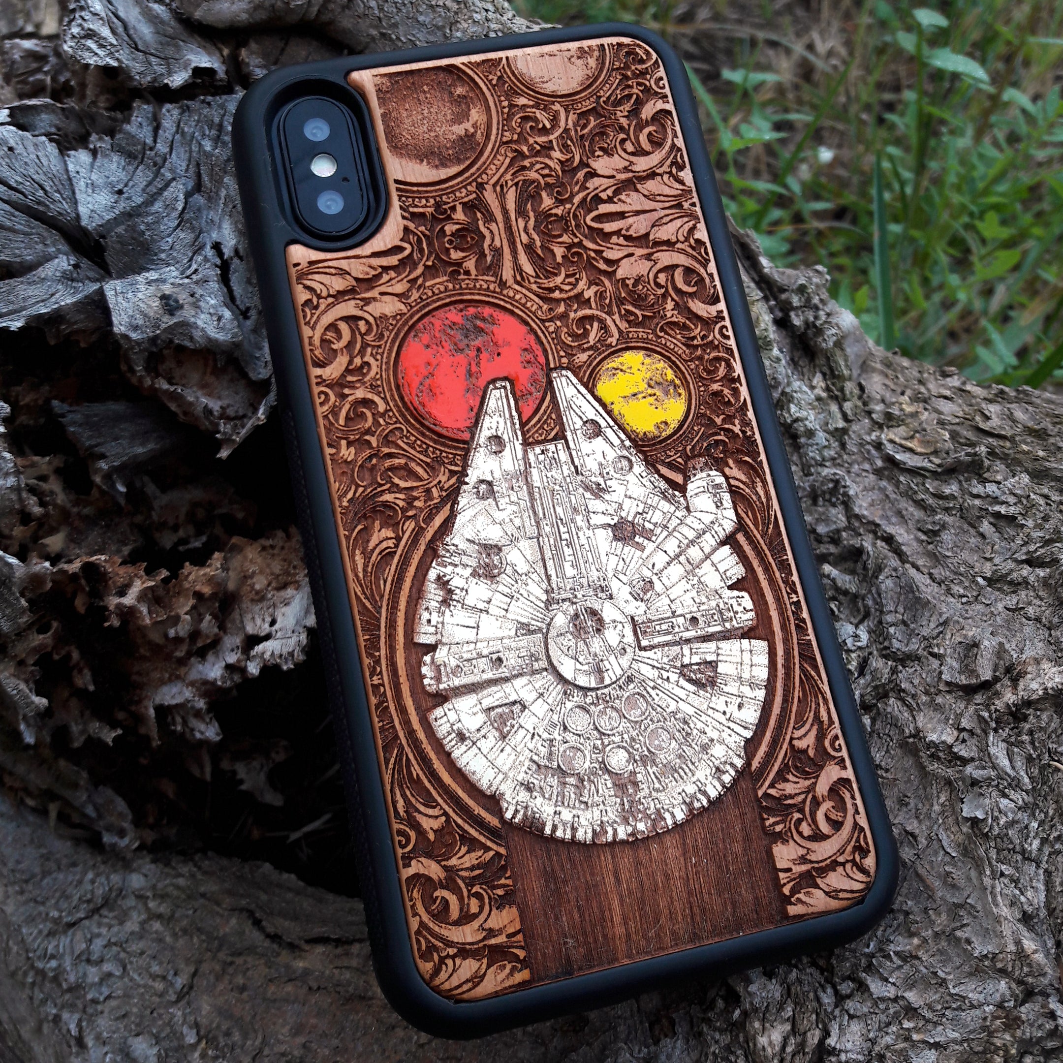 Detailed shot of Millennium Falcon wooden phone case with hand-painted and laser-engraved artwork. Cherrywood design for iPhone and Galaxy models.
