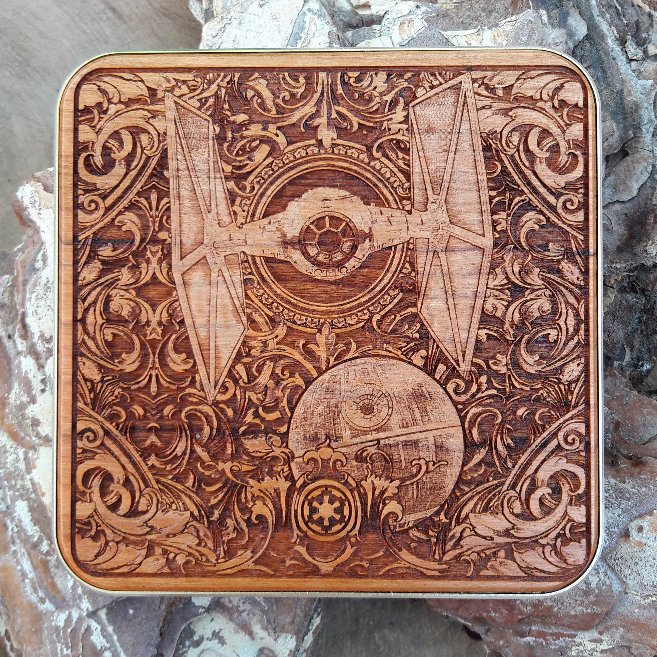 Wooden wireless charger engraved with Star Wars-style spaceships.