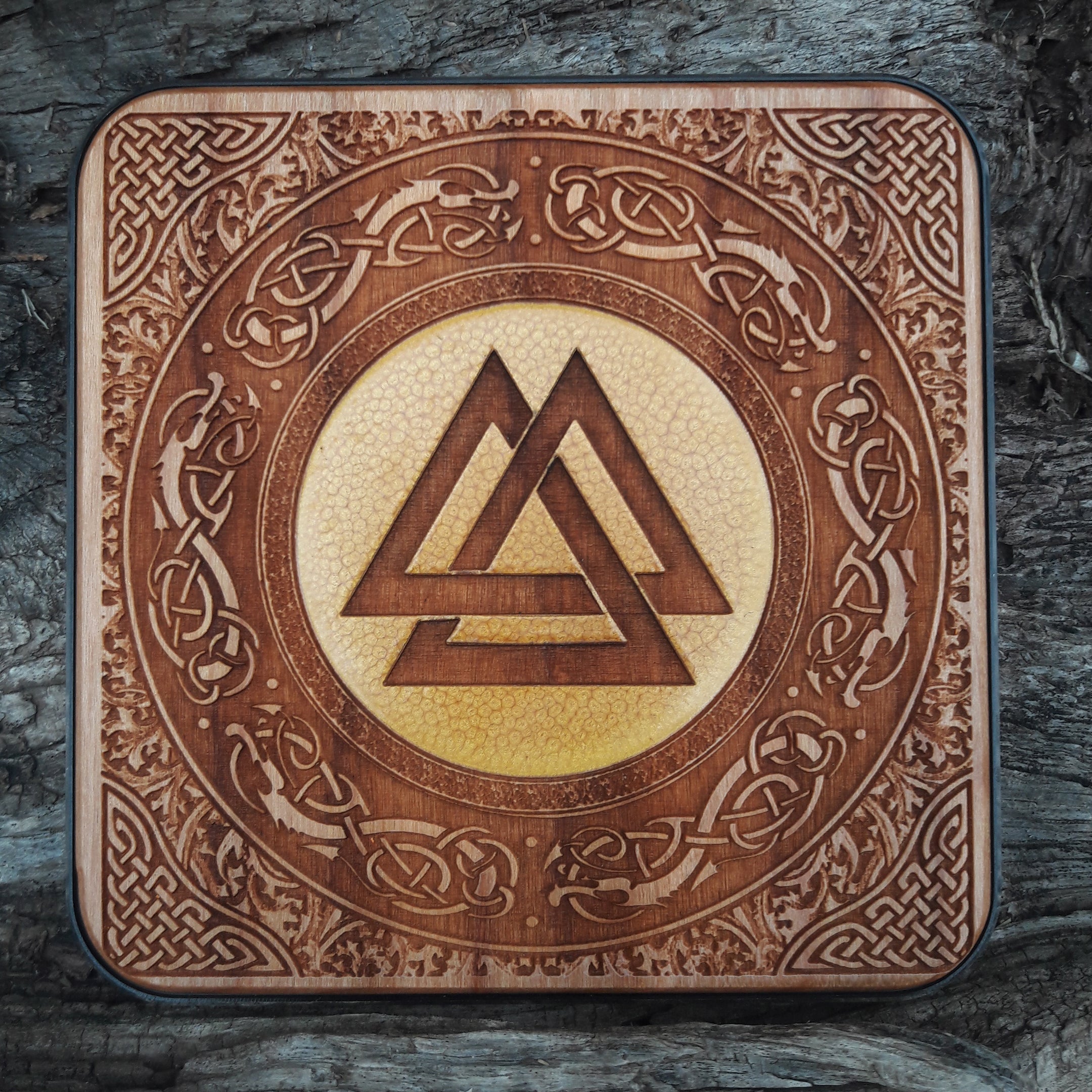 Hand-painted wooden wireless charger with Viking symbols.