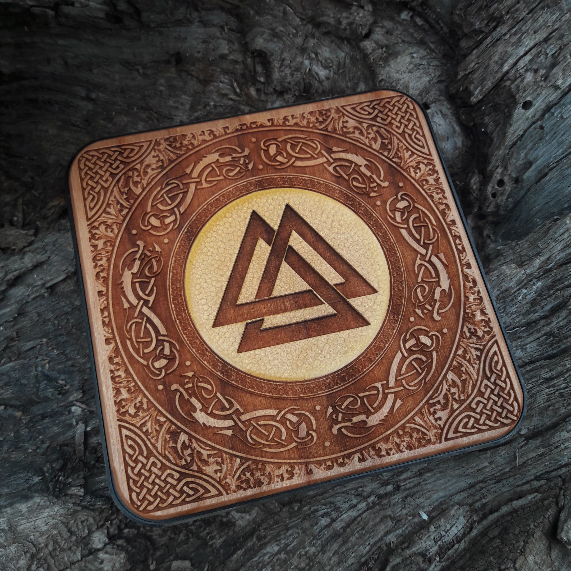 Wooden wireless charger featuring Norse runes and Nordic art.