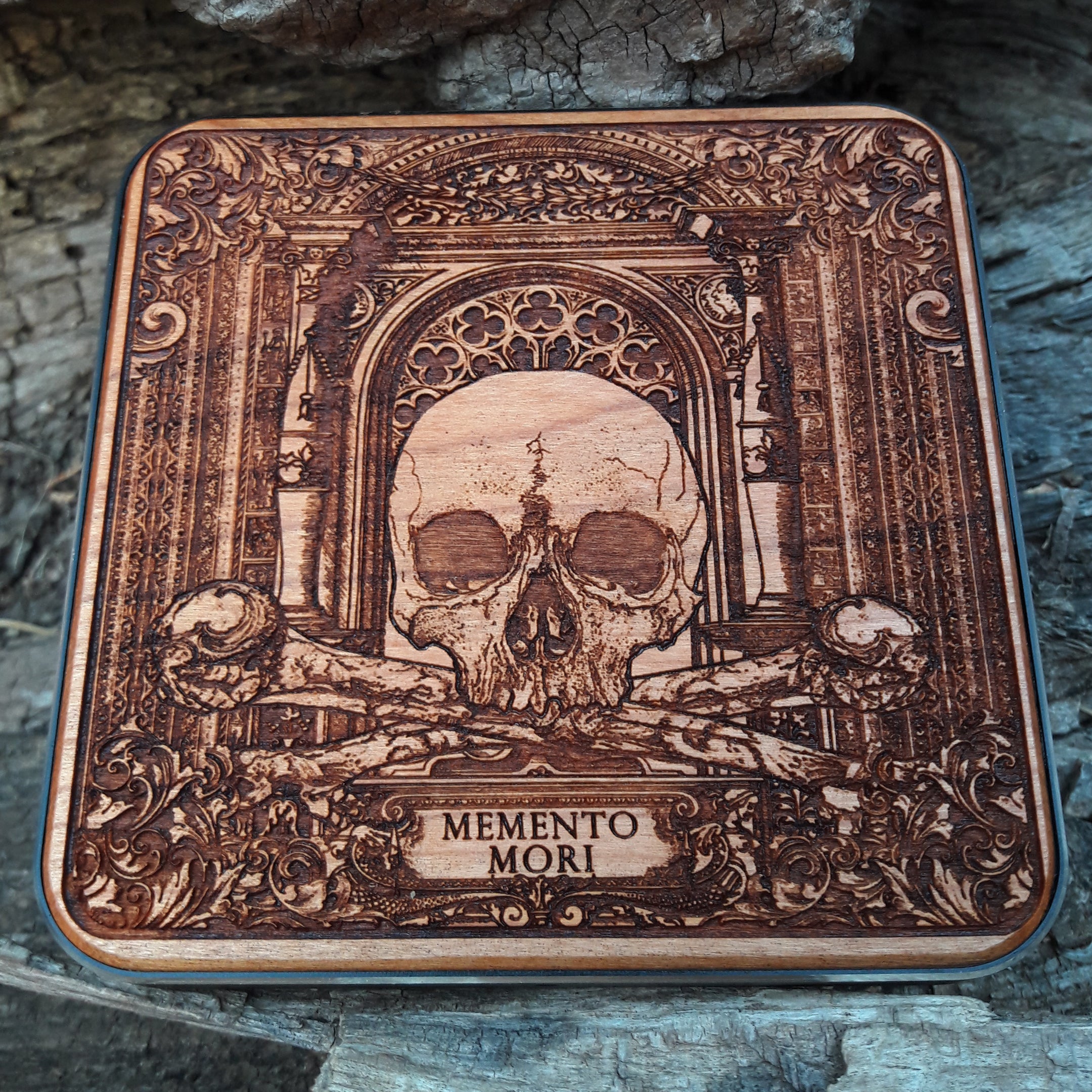 Close-up of engraved skull on memento mori wooden charger.