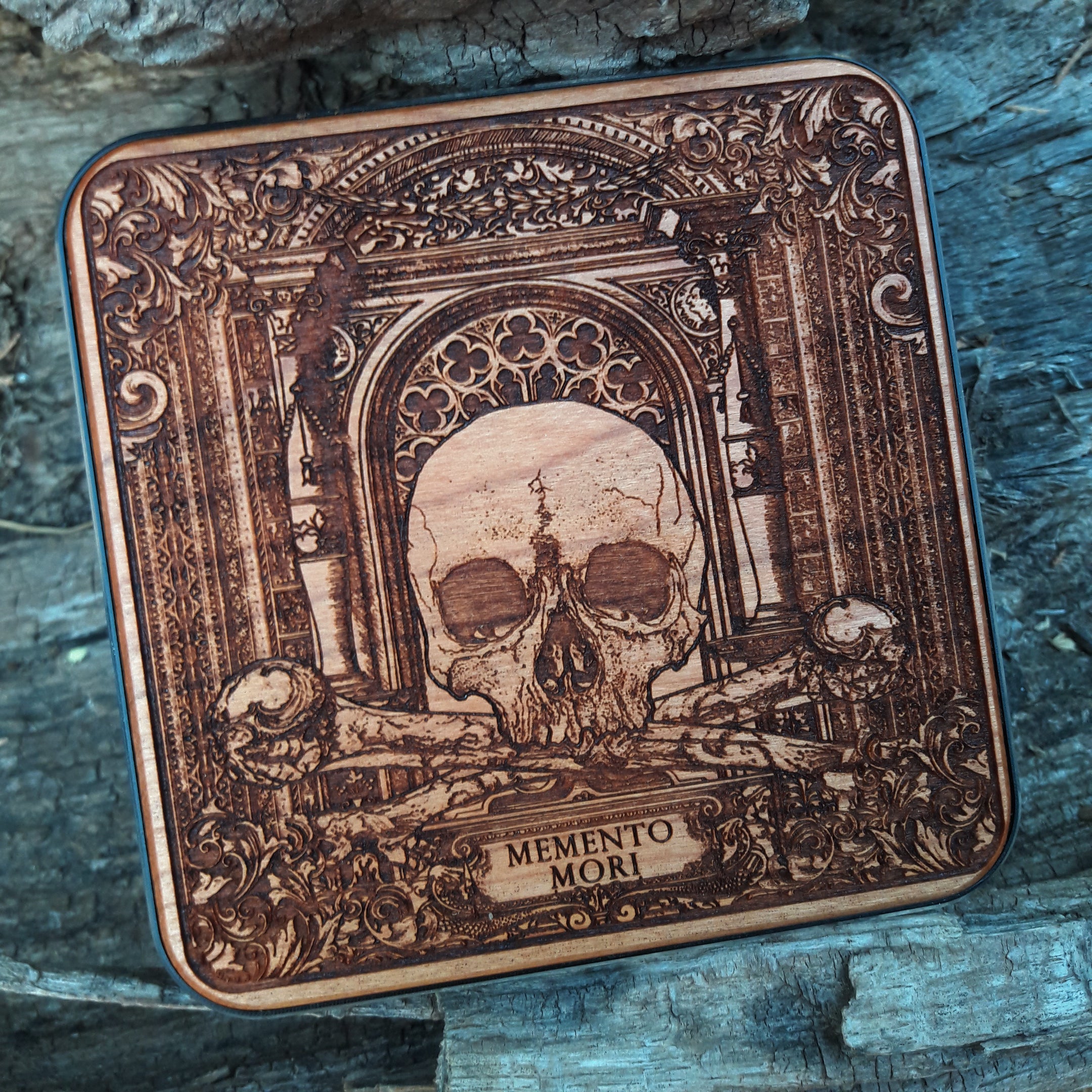 Overhead view of gothic skull artwork on wireless charger.