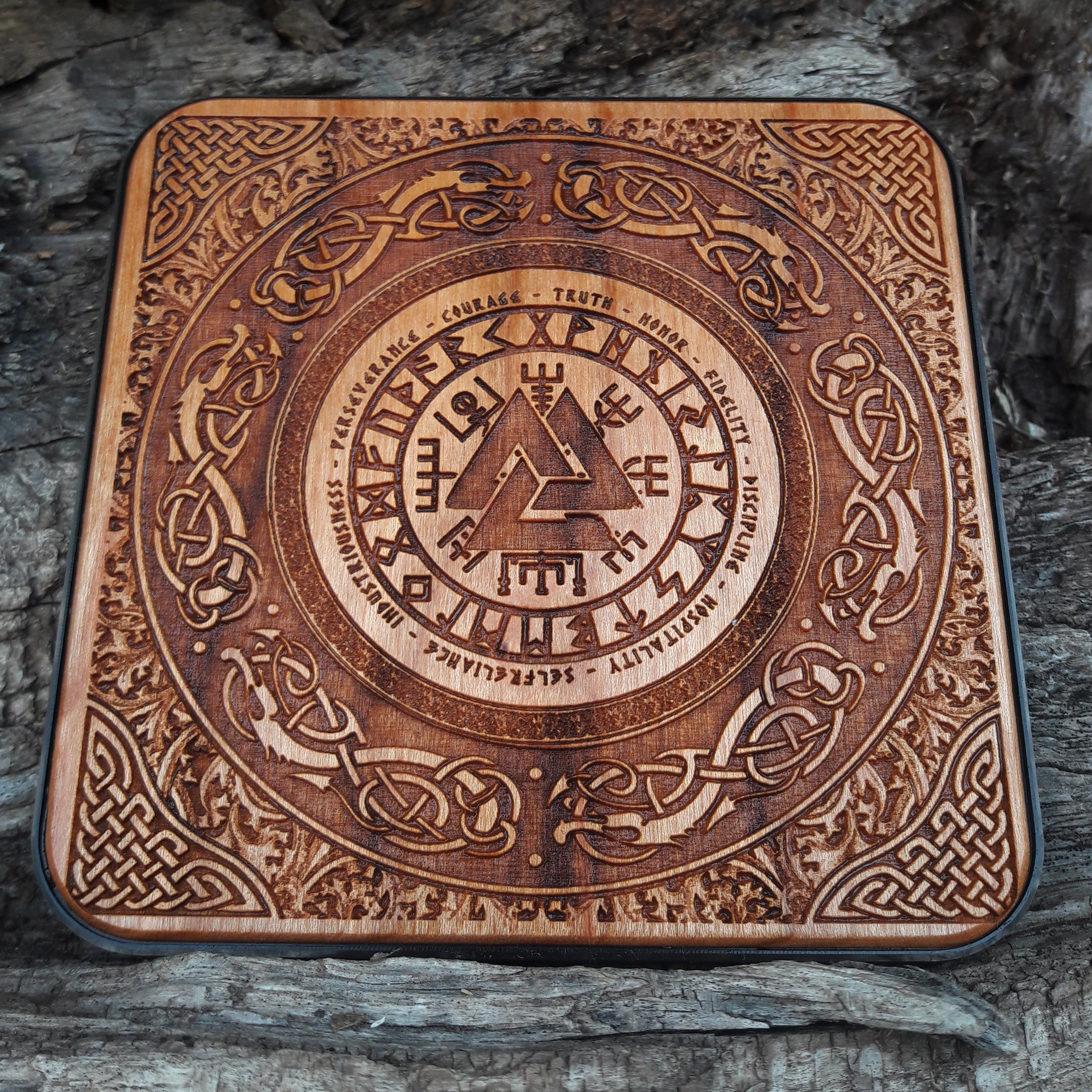 Close-up of Viking helmet art on wood wireless charger.