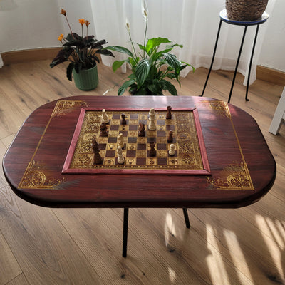 Handmade wooden chessboard coffee table with Roman laser engraving, pine and maple wood, gold details, red walnut finish.