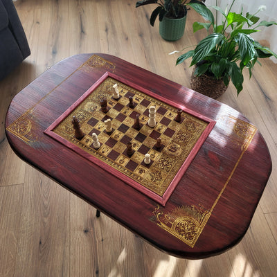 Handmade wooden chessboard coffee table with Roman laser engraving, pine and maple wood, gold details, red walnut finish.