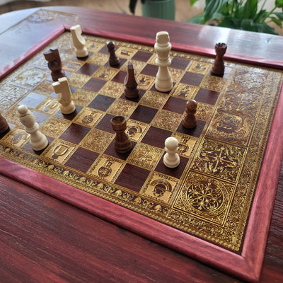 Handmade wooden chessboard coffee table with Roman laser engraving, pine and maple wood, gold details, red walnut finish.