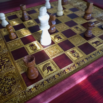 Handmade wooden chessboard coffee table with Roman laser engraving, pine and maple wood, gold details, red walnut finish.