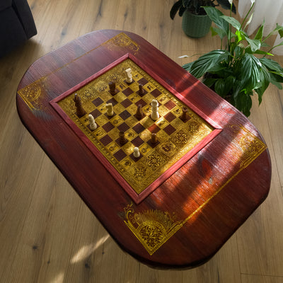 Handmade wooden chessboard coffee table with Roman laser engraving, pine and maple wood, gold details, red walnut finish.