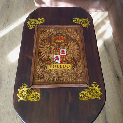 Handmade walnut stained wood coffee table with engraved hand-painted Toledo family crest cedar inlay