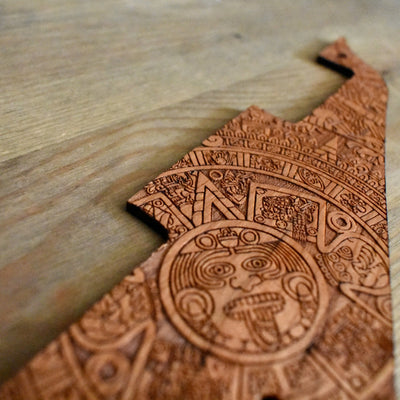 Close-up of laser-engraved Aztec design on cherrywood Les Paul pickguard.