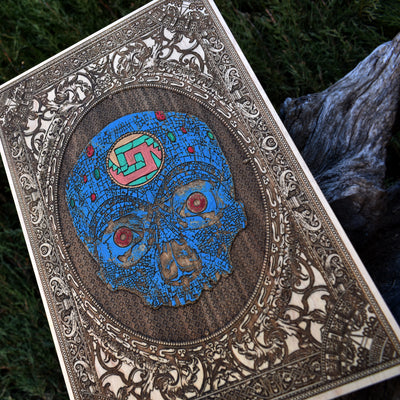 Wooden Aztec skull engraving with bold tribal details and natural wood texture.