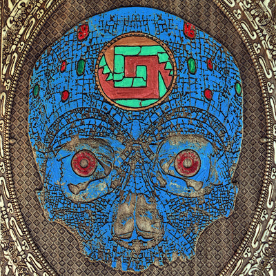 Engraved Aztec skull on wood, featuring ancient tribal-style symbolism.
