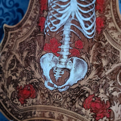 Skeletal design with red floral elements on a detailed background