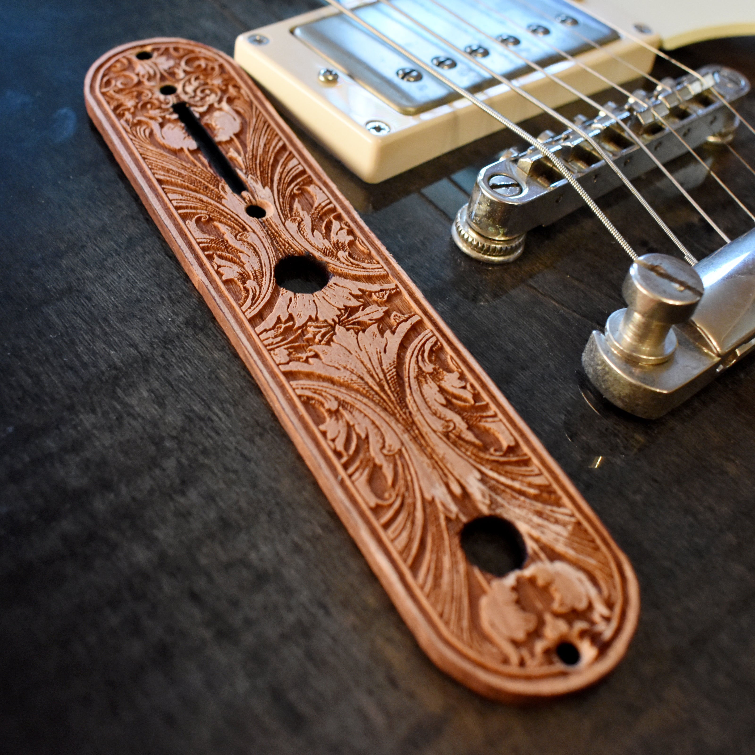 Laser‑engraved floral scrollwork wood control plate replacement for Telecaster guitar in warm brown finish