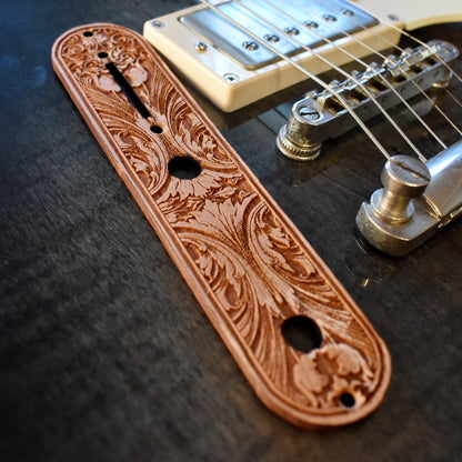 Laser‑engraved floral scrollwork wood control plate replacement for Telecaster guitar in warm brown finish