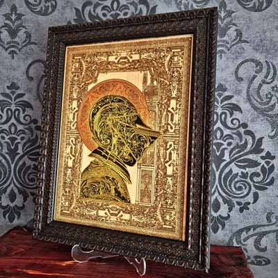 Black-and-gold medieval knight helmet maple wood wall art, angled view in an ornate dark brown frame