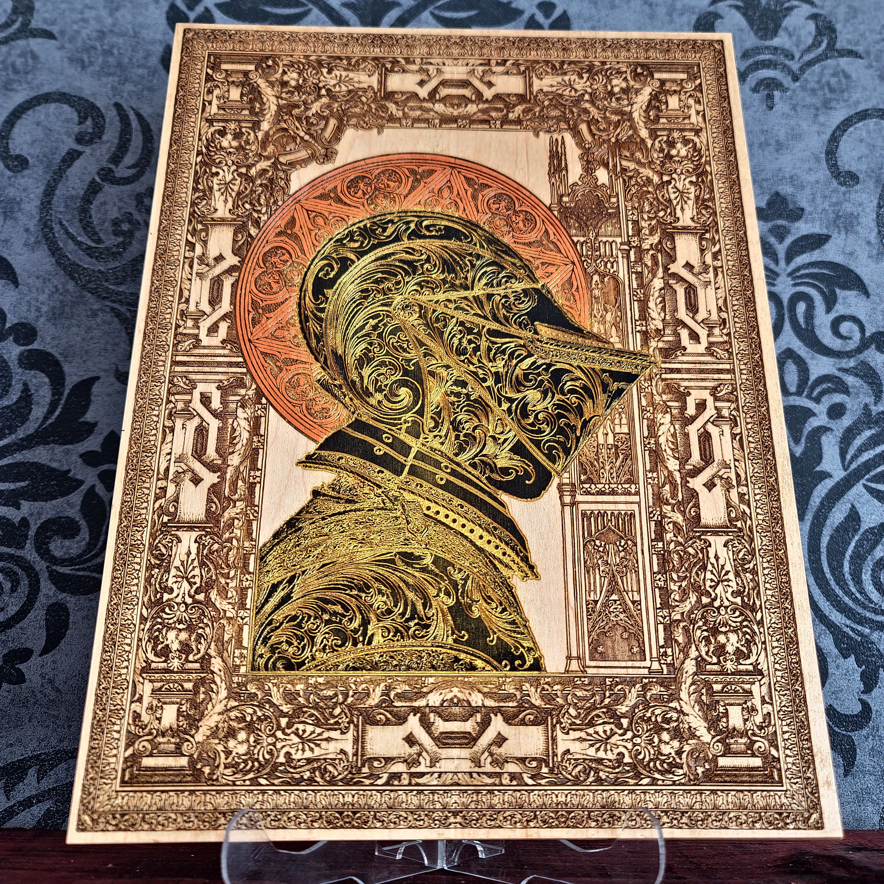 Black-and-gold medieval knight helmet maple wood wall art, unframed front view with ornate architectural border