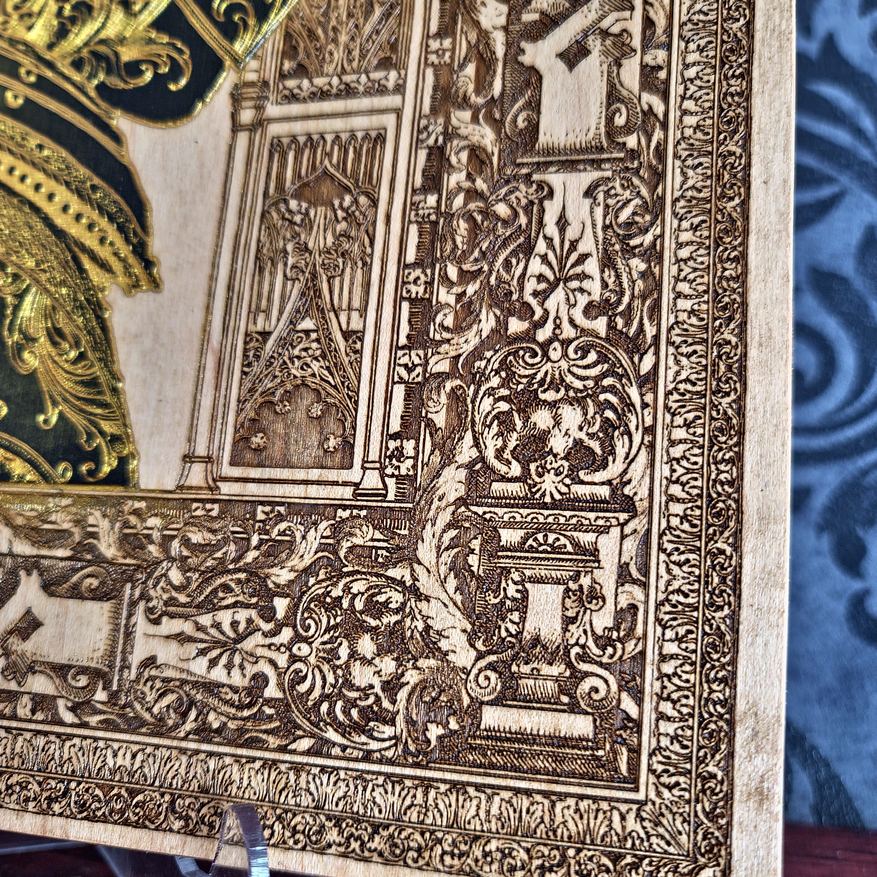 Black-and-gold medieval knight helmet maple wood wall art, close-up of the engraved border and knight armour