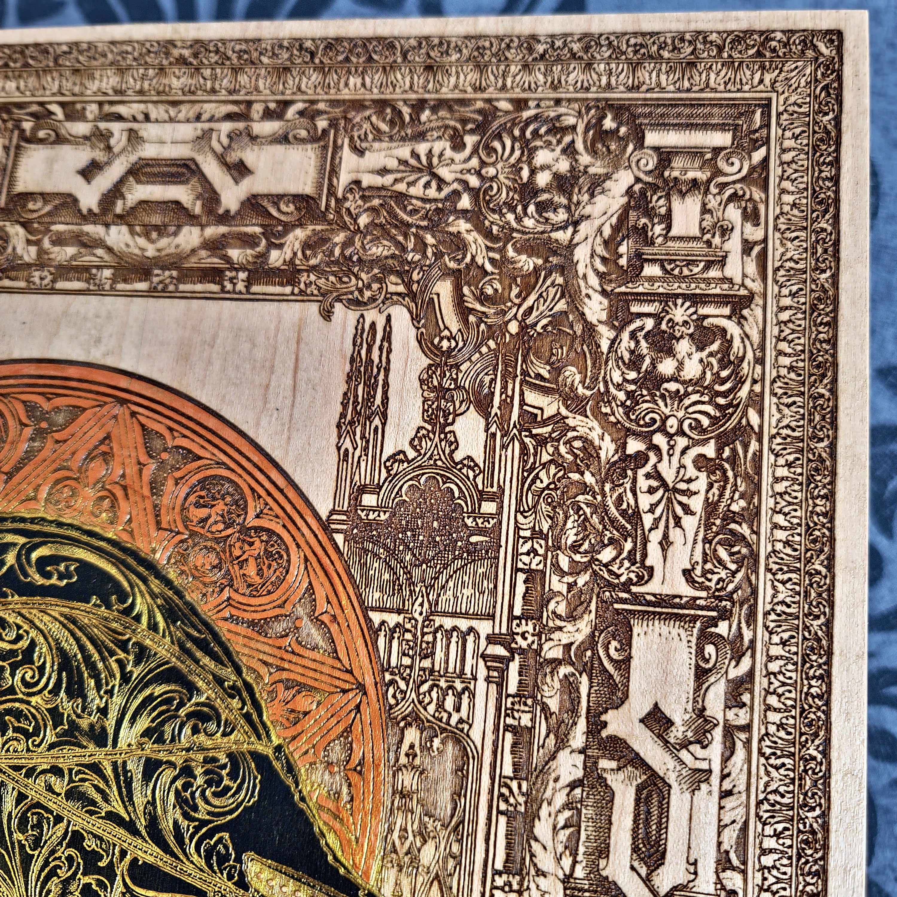 Black-and-gold medieval knight helmet maple wood wall art, close-up of the upper architectural border and helmet edge