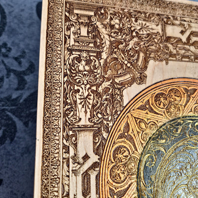 Black-and-gold medieval knight helmet maple wood wall art, close-up of the carved border and orange halo